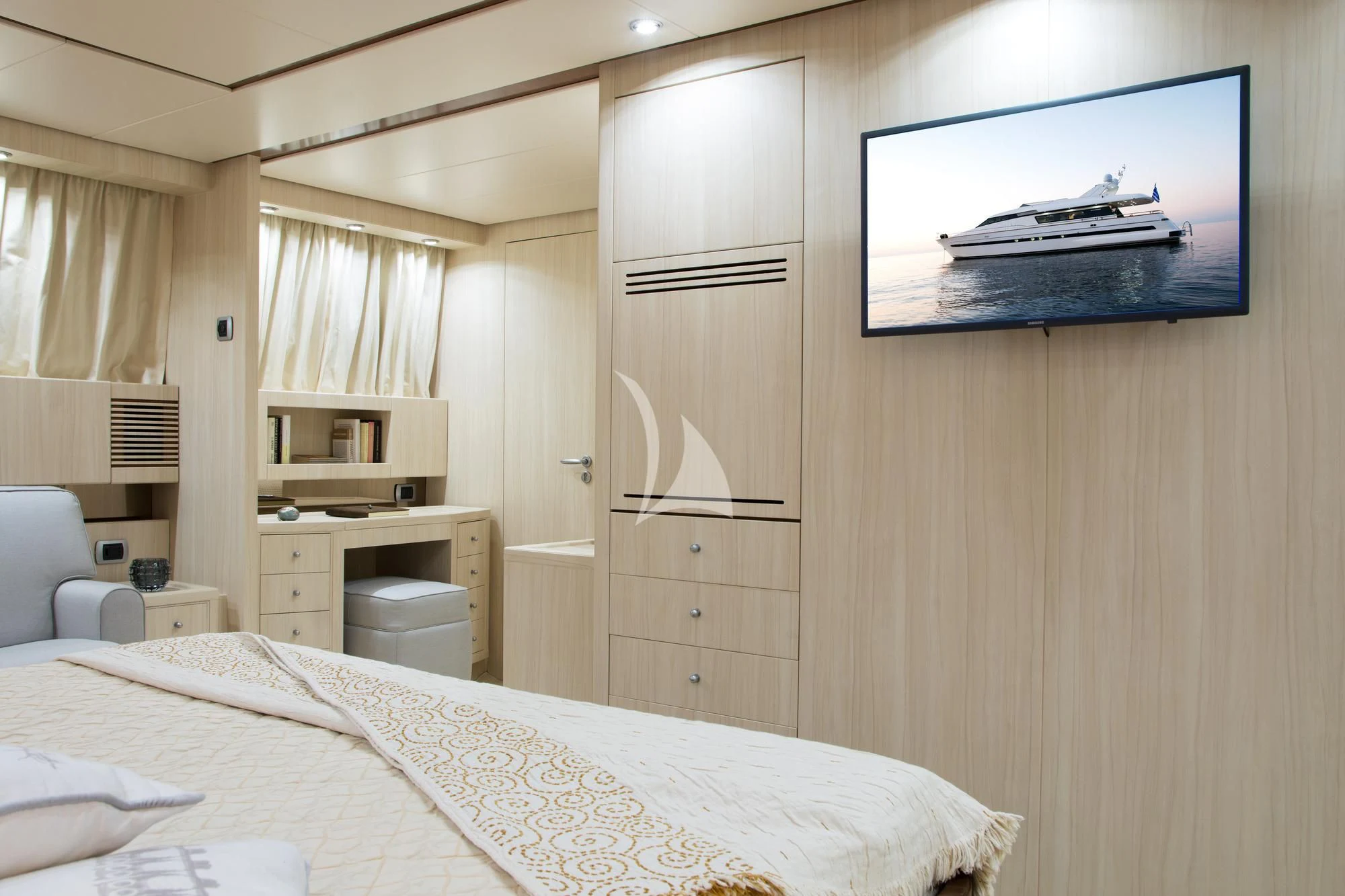 a bedroom with a bed and a television aboard ACIONNA Yacht for Sale