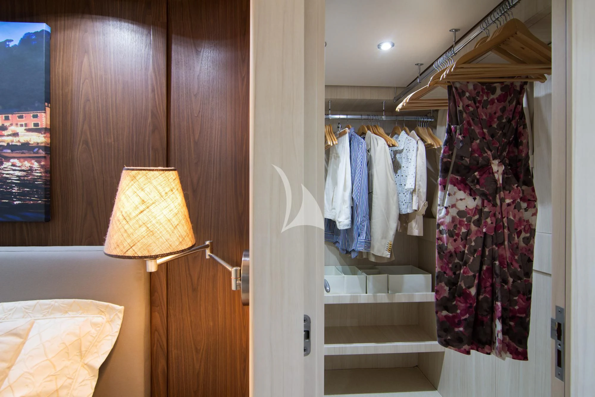a closet with clothes on the wall aboard ACIONNA Yacht for Sale