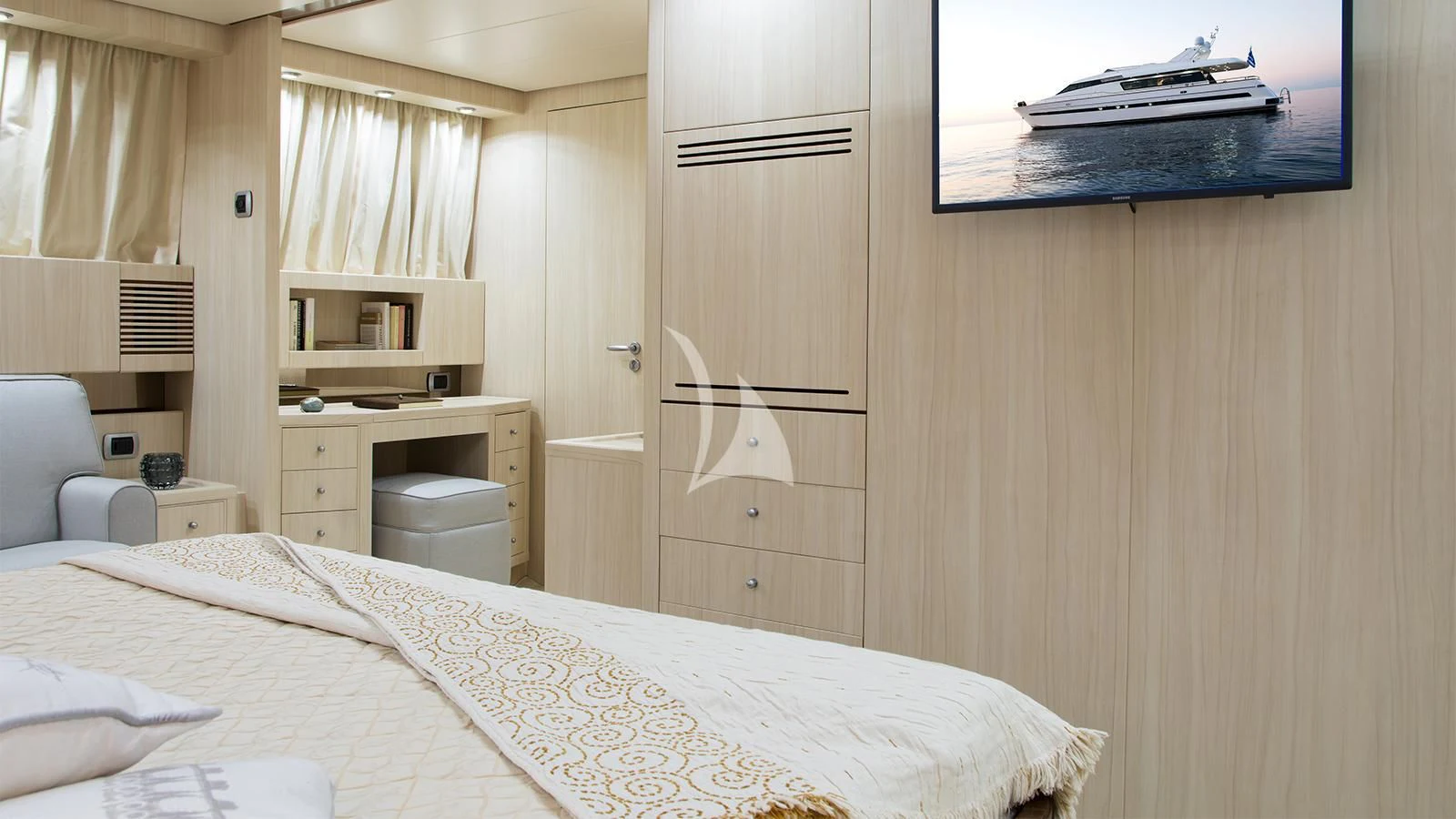 a bedroom with a bed and a desk aboard ACIONNA Yacht for Sale