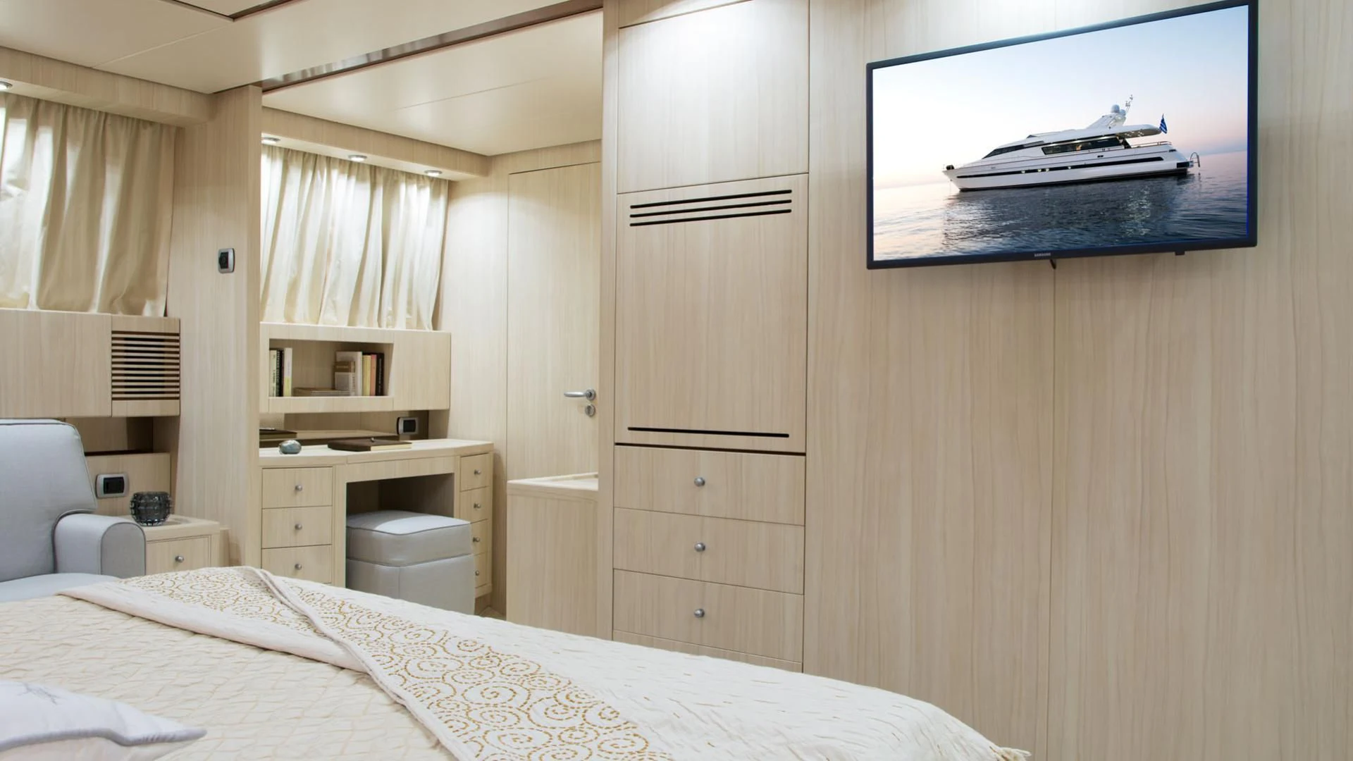 a room with a bed and a television aboard ACIONNA Yacht for Sale