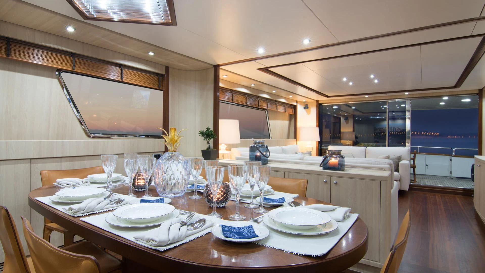 a large kitchen with a table set aboard ACIONNA Yacht for Sale