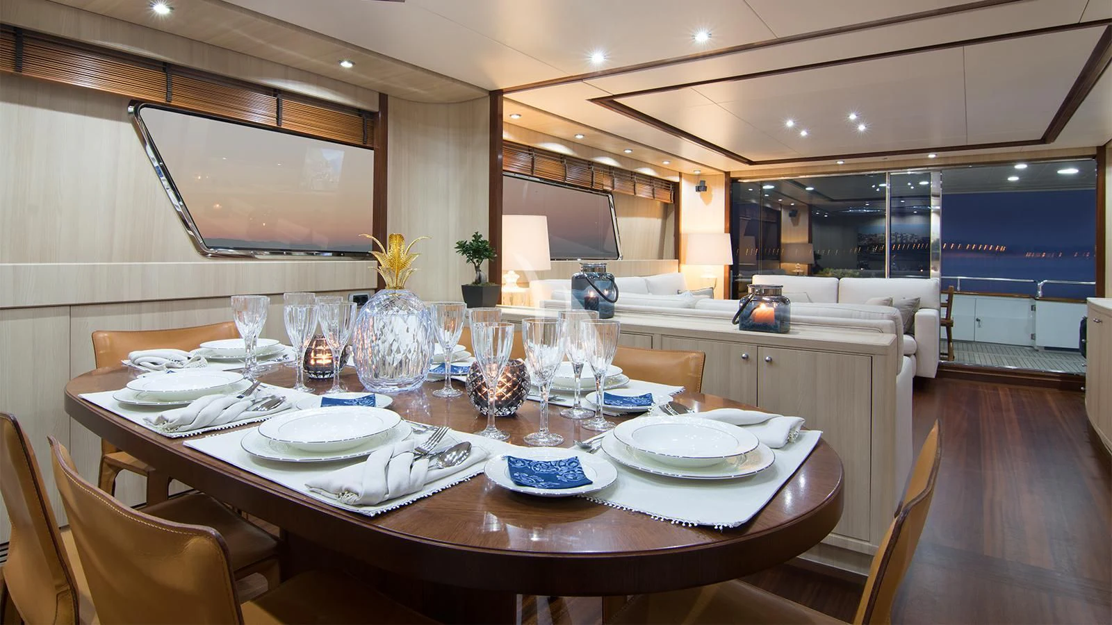a table with plates and glasses on it aboard ACIONNA Yacht for Sale