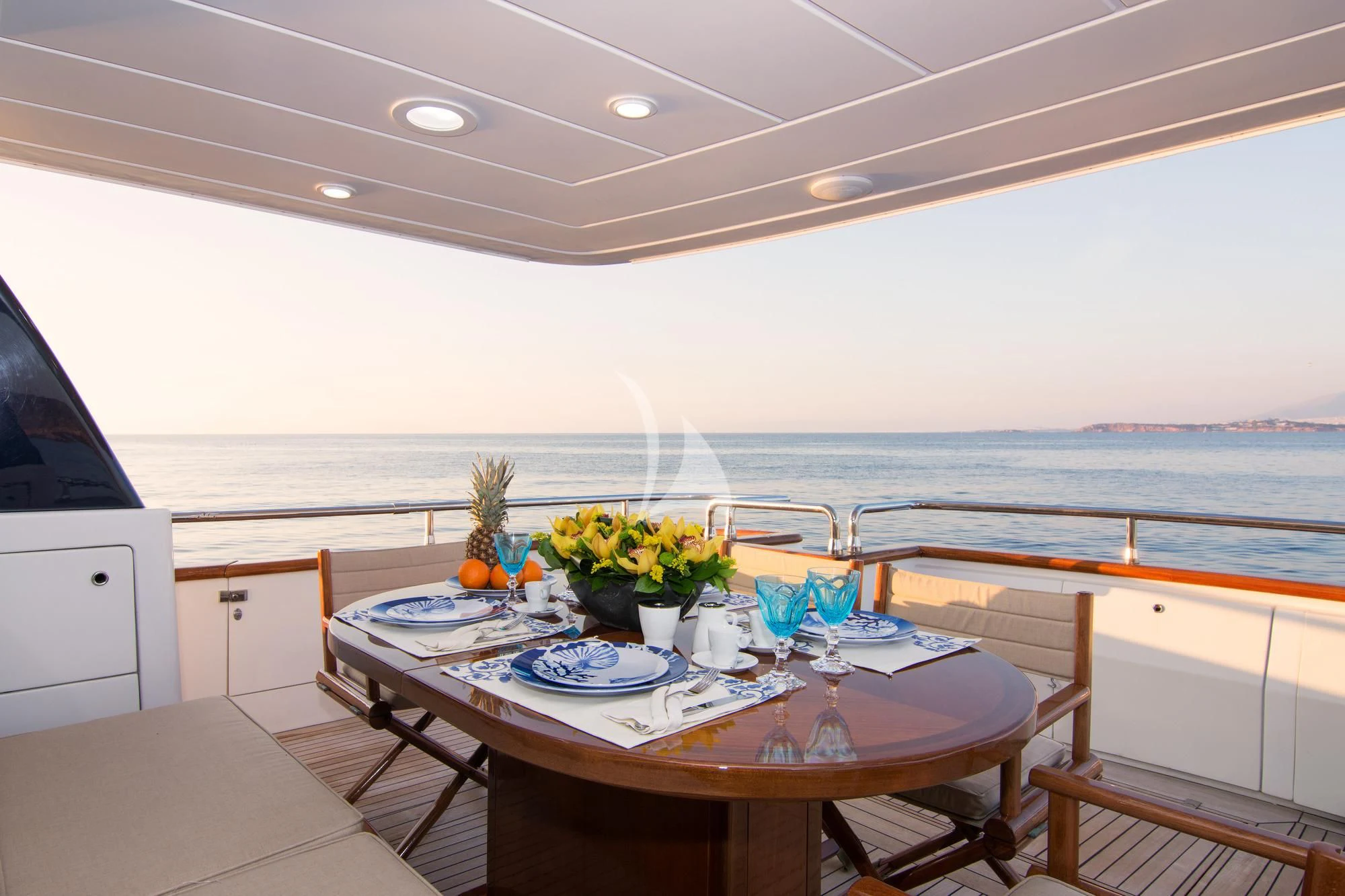 a table with plates and cups on it aboard ACIONNA Yacht for Sale