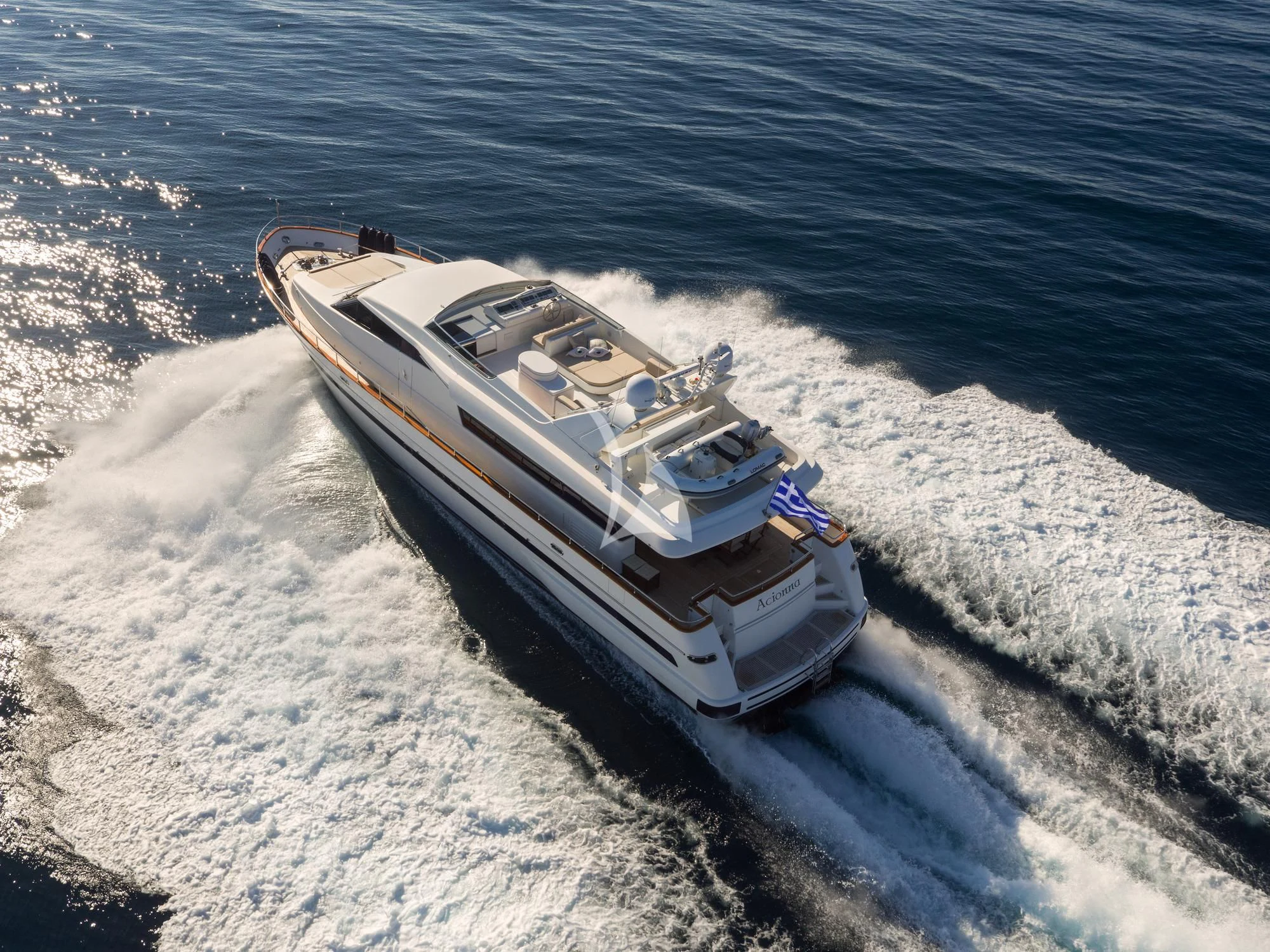 a military tank driving on a beach aboard ACIONNA Yacht for Sale