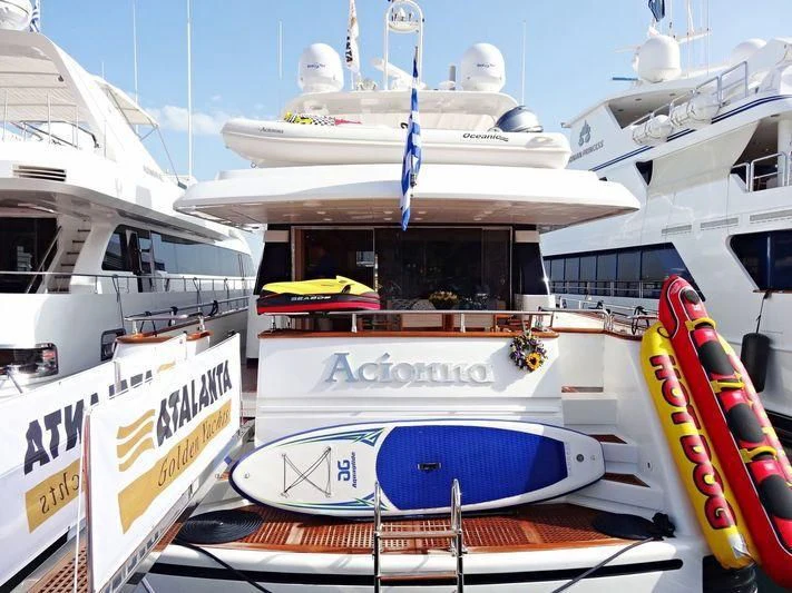 a boat docked at a pier aboard ACIONNA Yacht for Sale