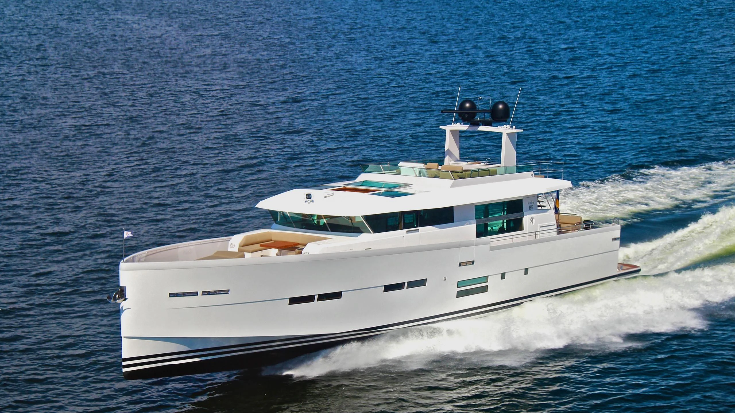 a white boat on the water aboard BIG BEAVER Yacht for Sale