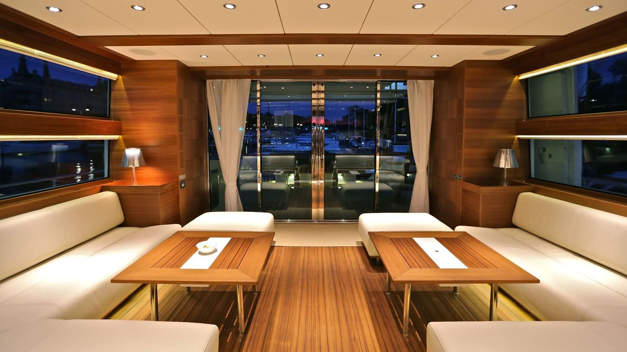 a room with a table and couches aboard BIG BEAVER Yacht for Sale