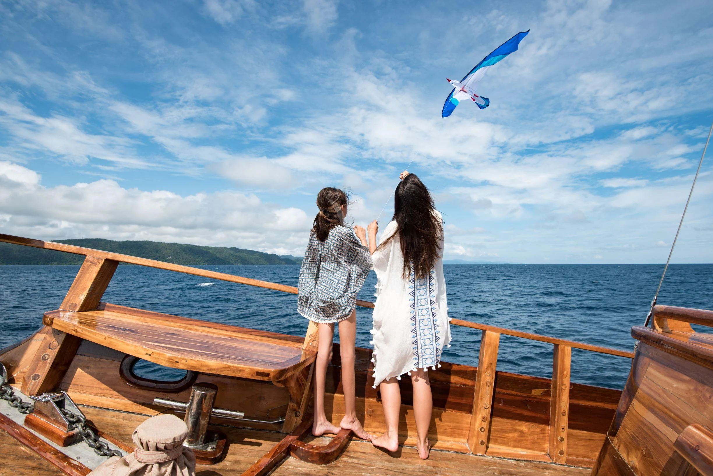 a couple of women flying a kite on a boat aboard SEQUOIA Yacht for Sale