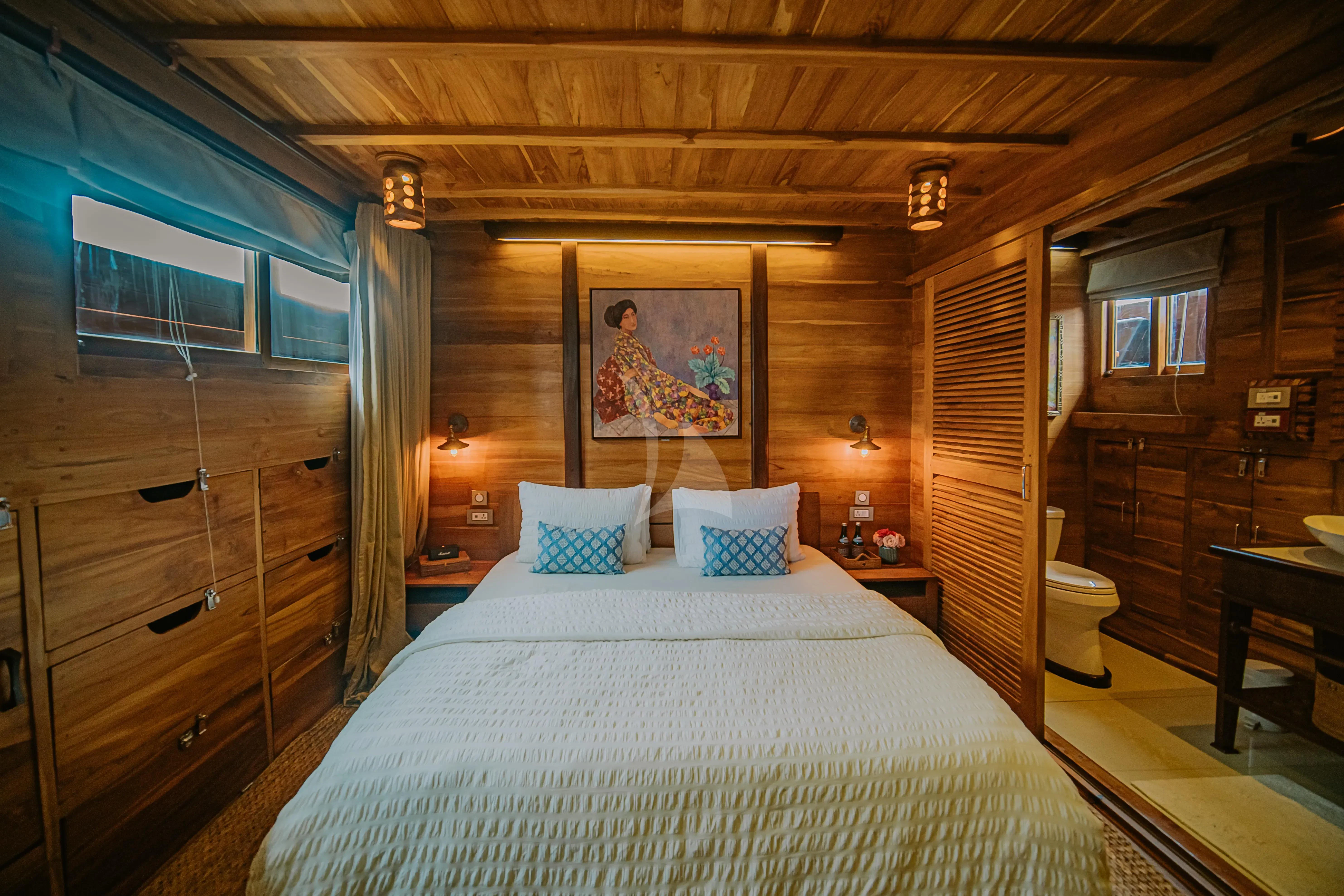 a bedroom with a bed and a wood door aboard SEQUOIA Yacht for Sale