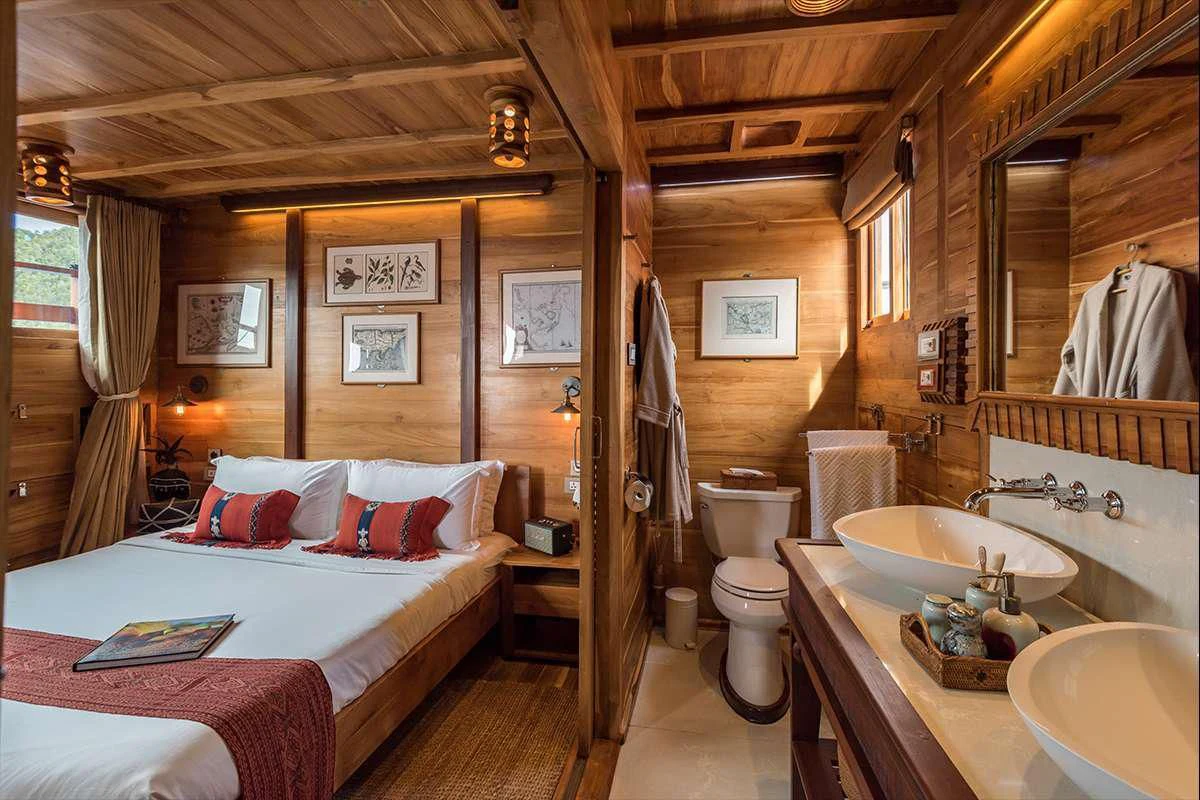 a bedroom with a bed and sink aboard SEQUOIA Yacht for Sale