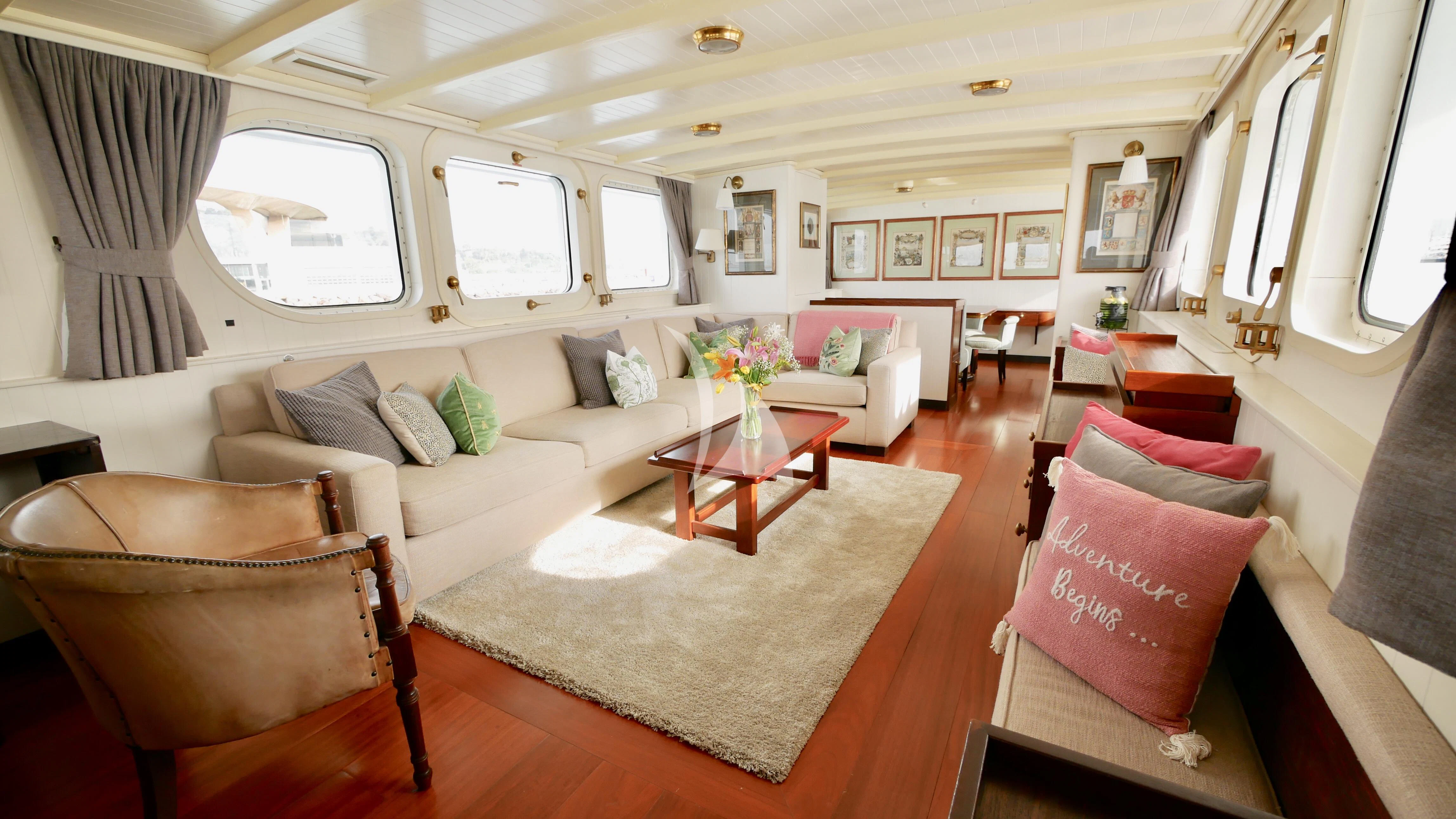 a living room with a couch and a rug aboard ABELY Yacht for Sale