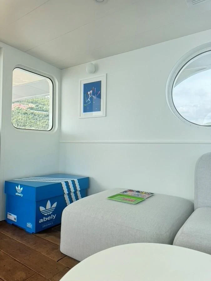 a room with a couch and a table aboard ABELY Yacht for Sale