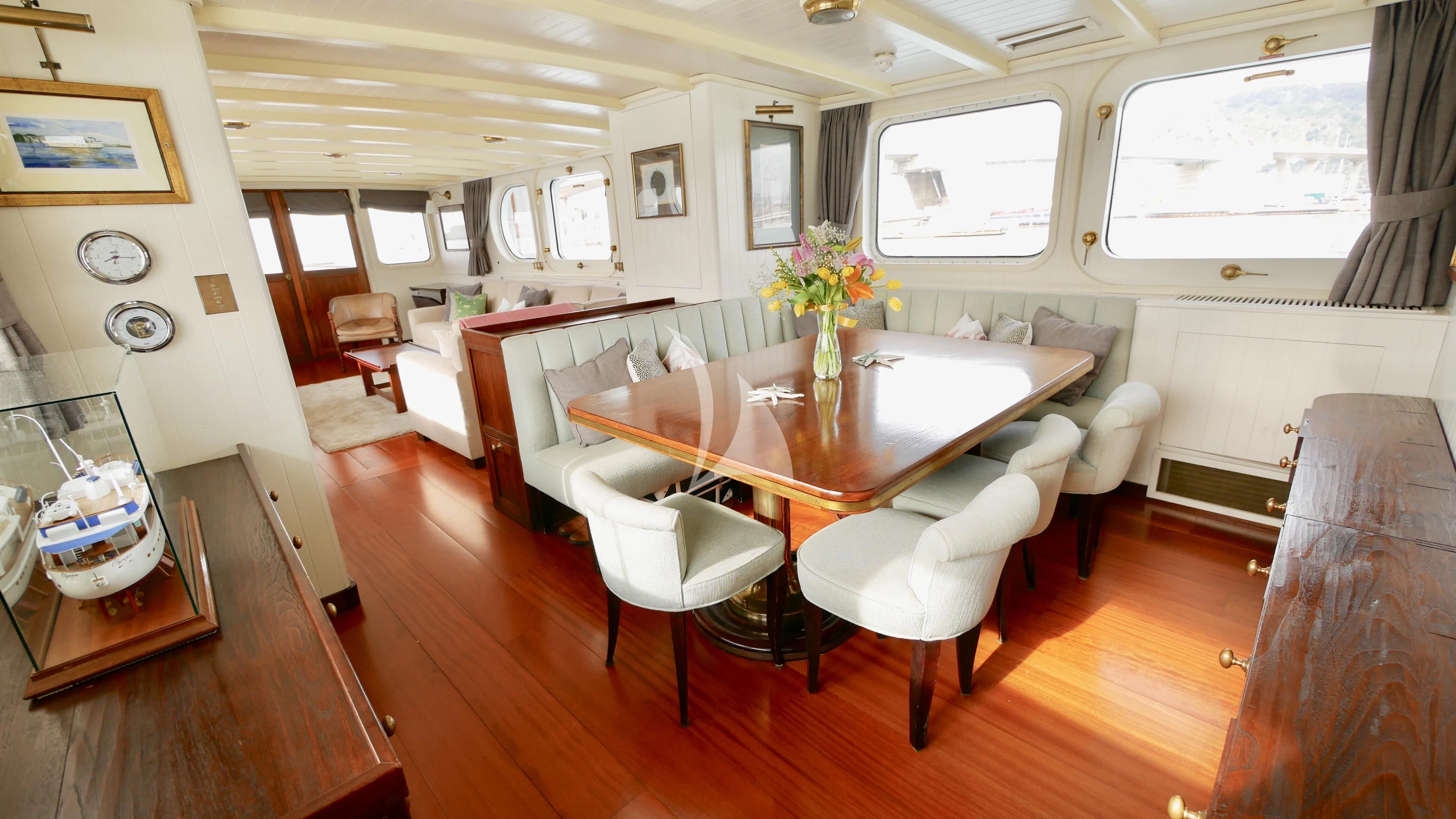 a dining room with a table and chairs aboard ABELY Yacht for Sale
