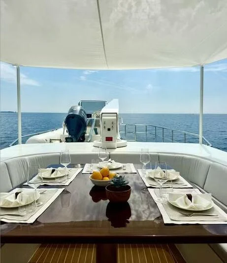 a table with plates and glasses on it aboard ABELY Yacht for Sale