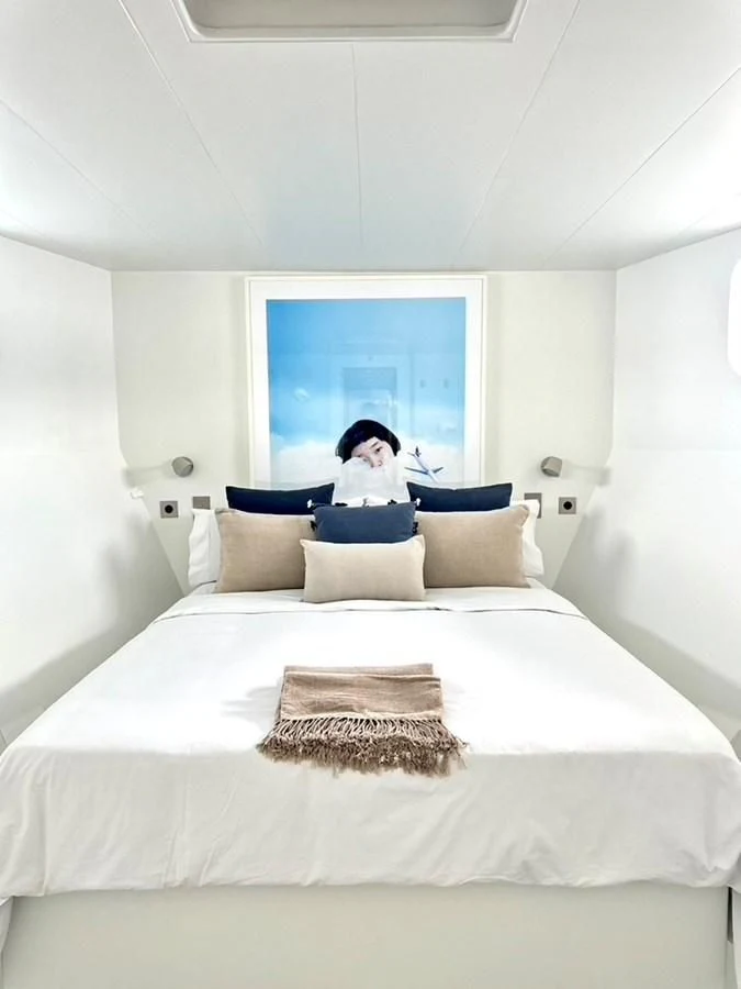 a person sitting on a bed aboard ABELY Yacht for Sale