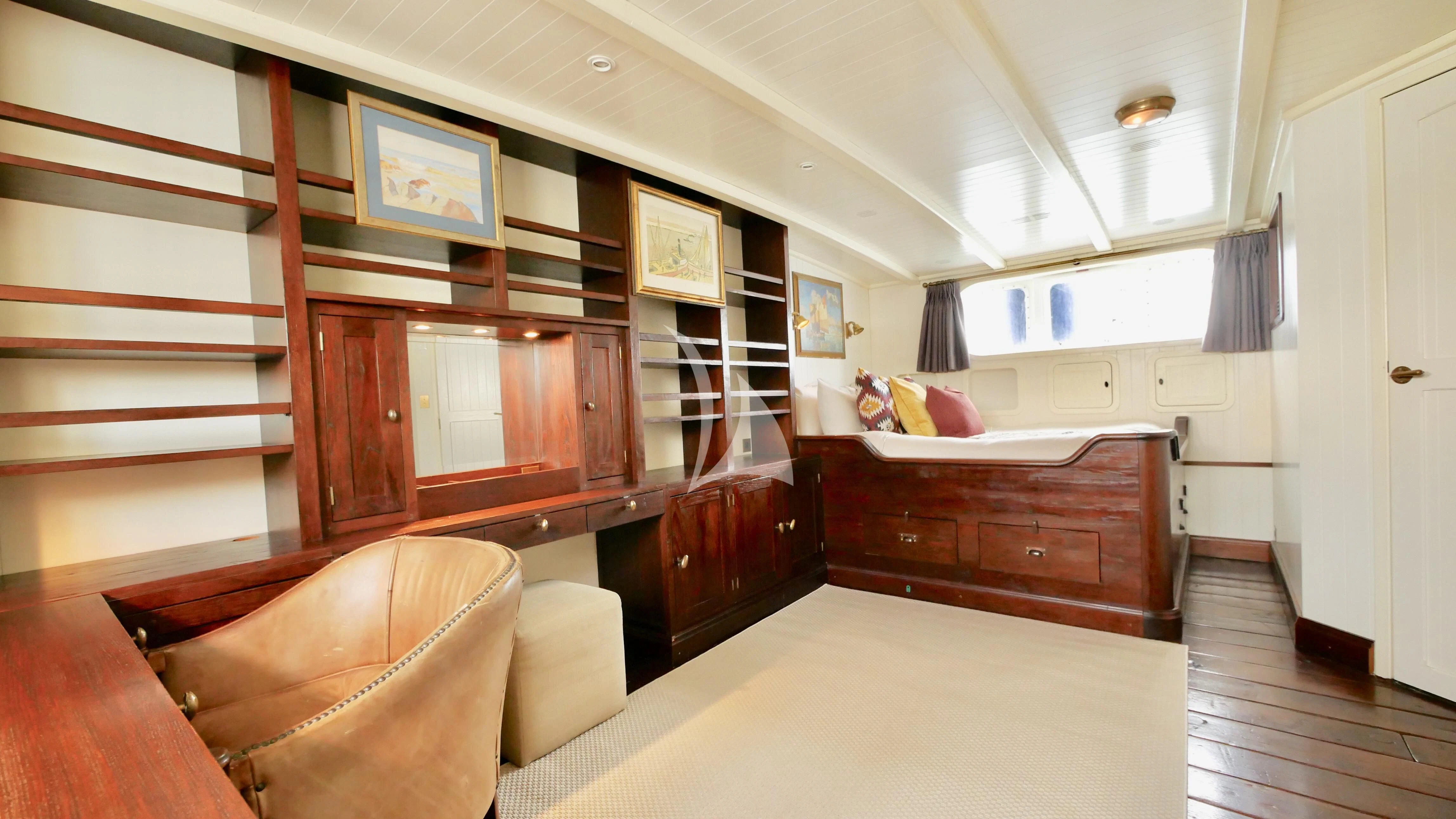 a room with a bed and a couch aboard ABELY Yacht for Sale