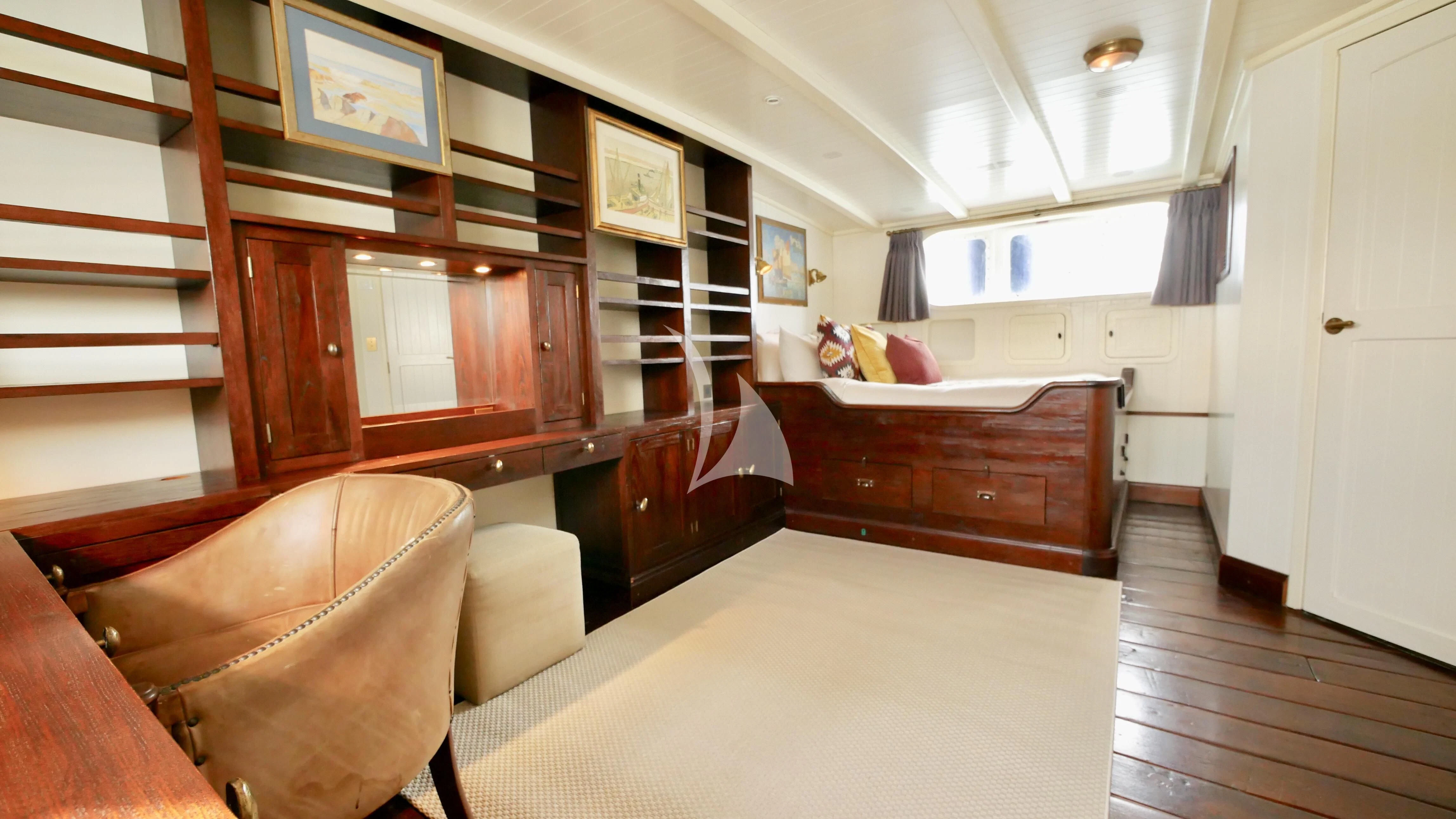 a bedroom with a bed and a desk aboard ABELY Yacht for Sale