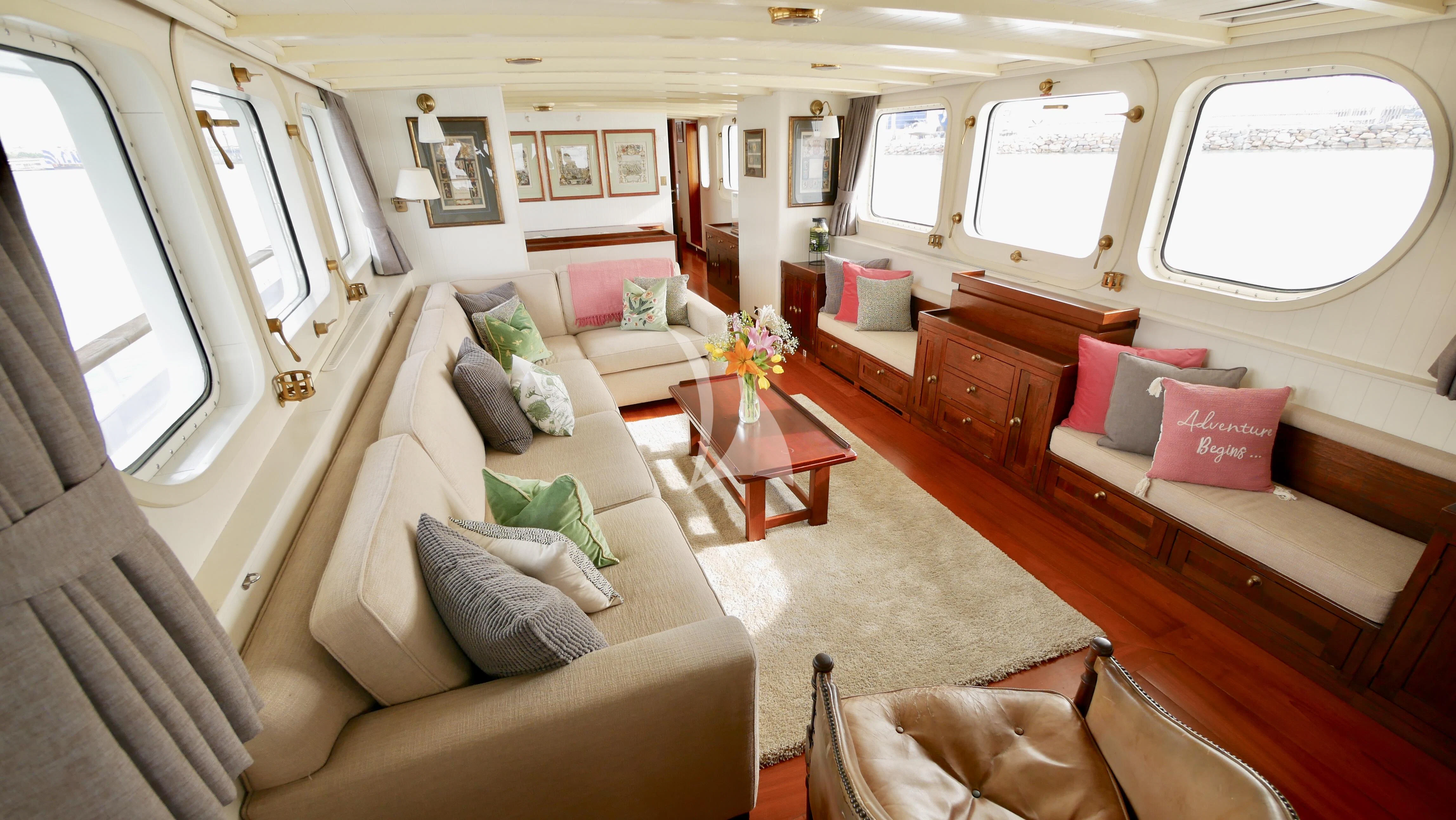 a living room with a couch and a table aboard ABELY Yacht for Sale