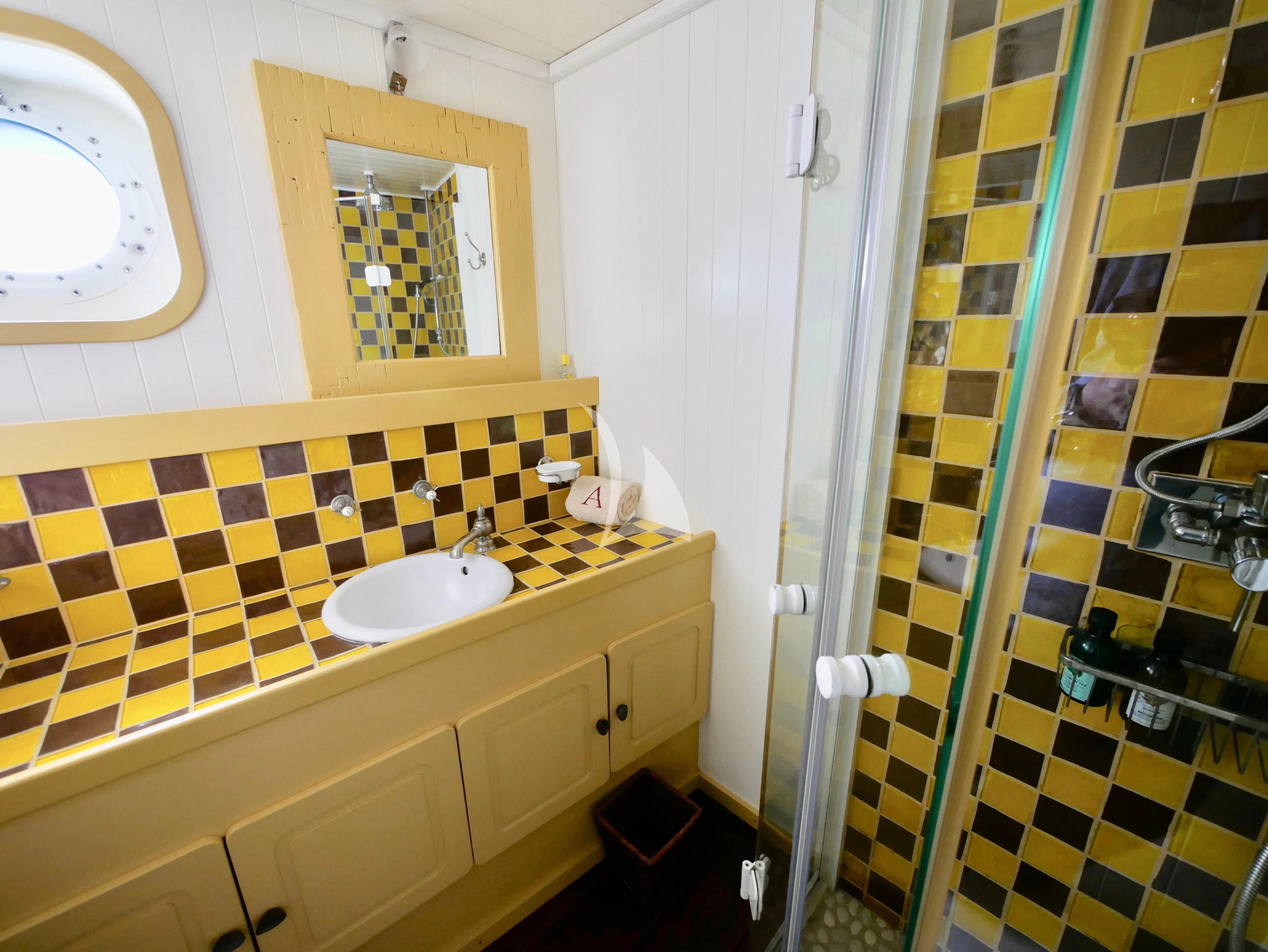 a bathroom with a sink and a shower aboard ABELY Yacht for Sale