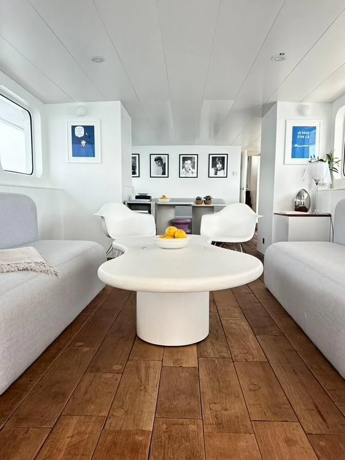 a living room with white furniture aboard ABELY Yacht for Sale
