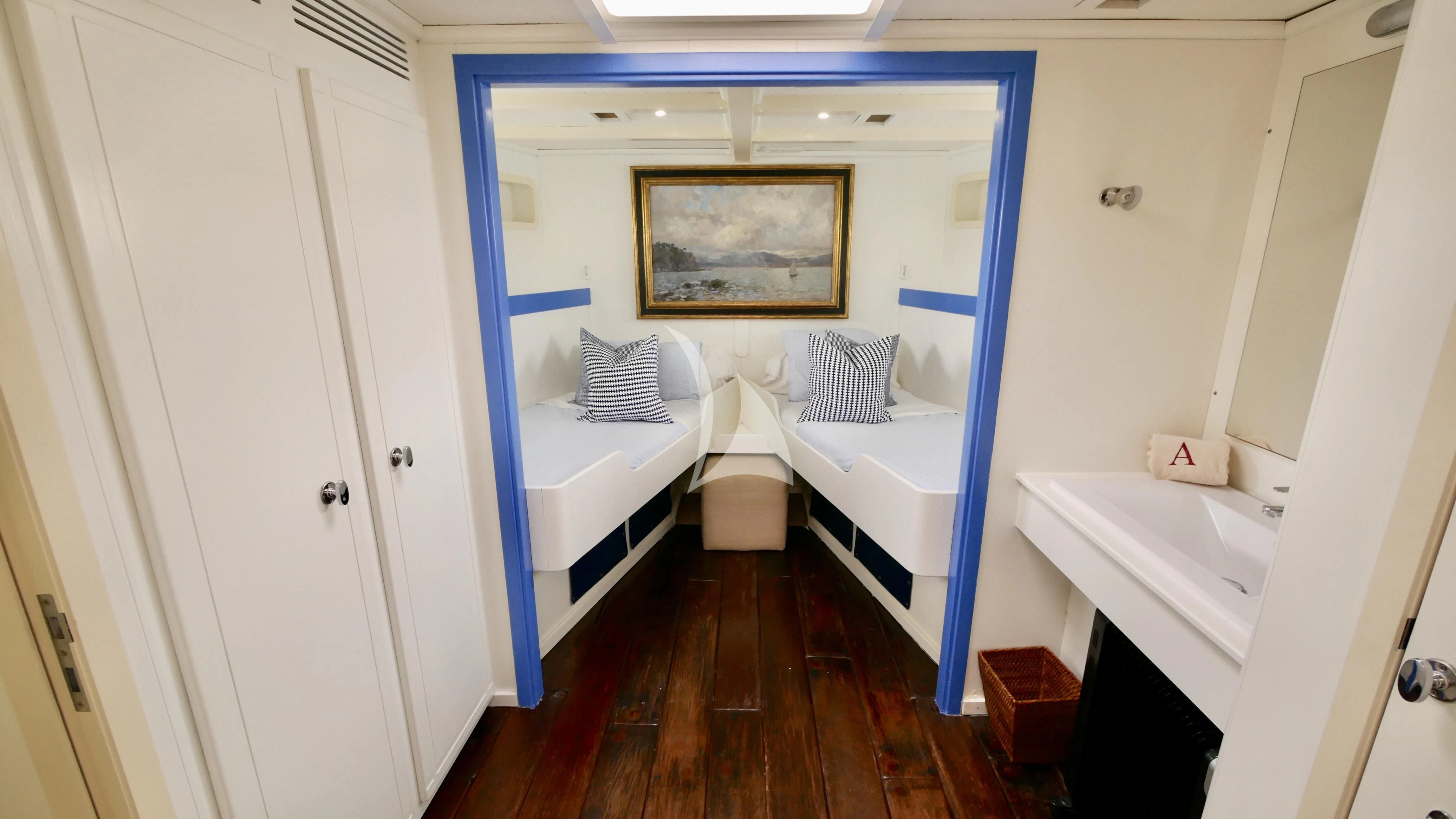 a bedroom with a wood floor aboard ABELY Yacht for Sale