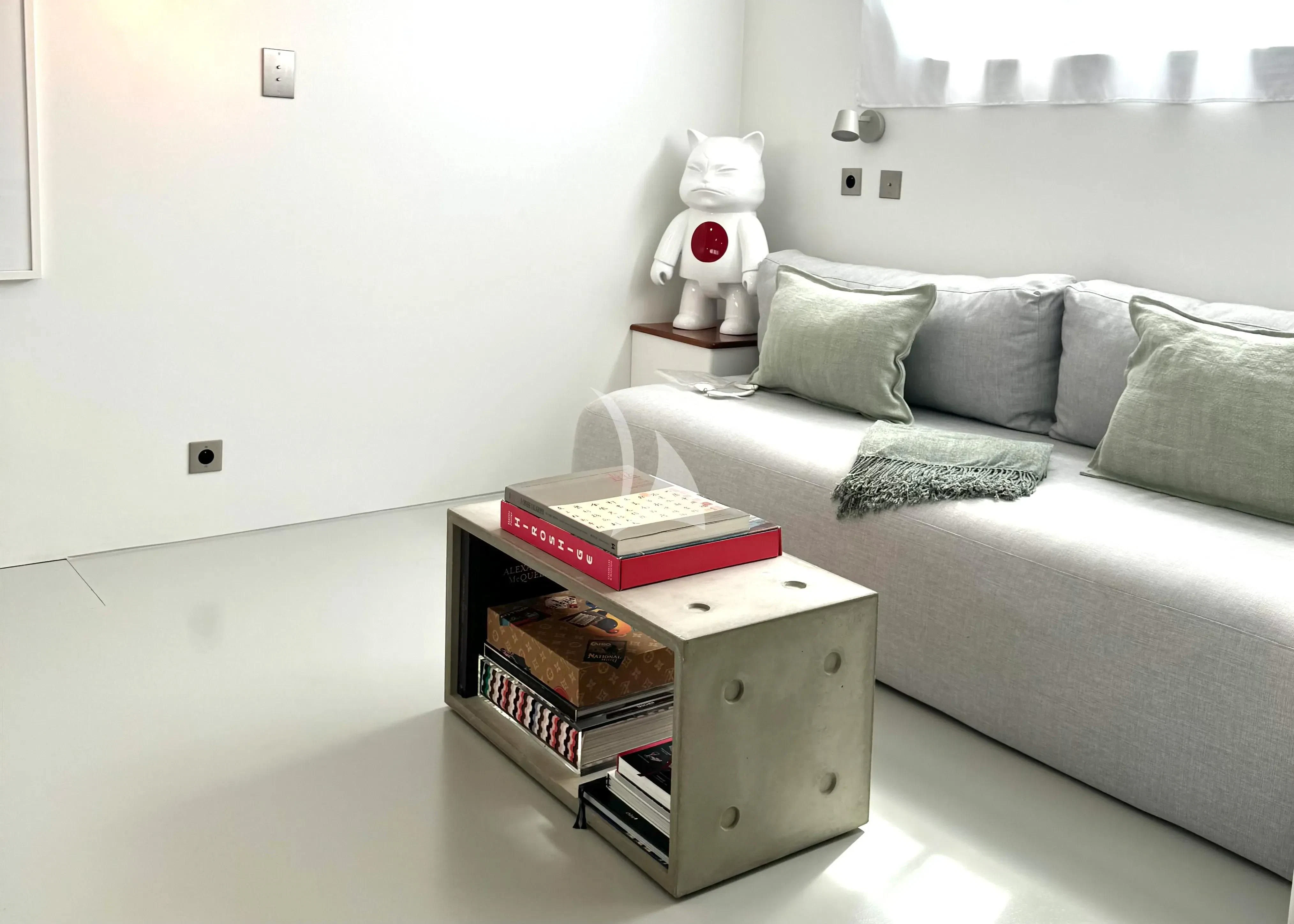 a couch with a coffee table and a book on it aboard ABELY Yacht for Sale