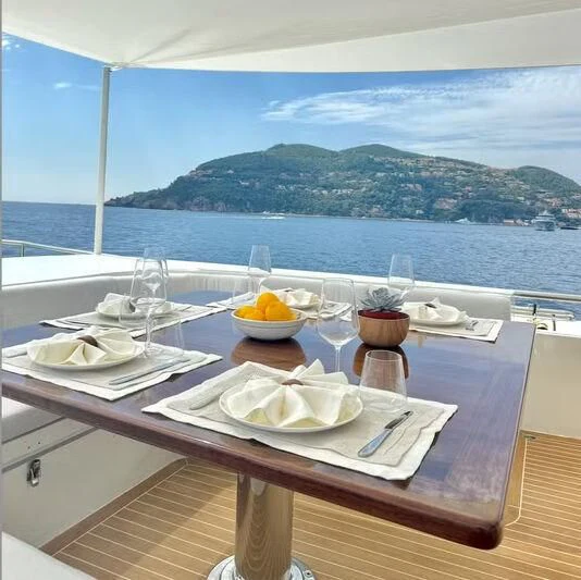 a table with plates and glasses on it aboard ABELY Yacht for Sale