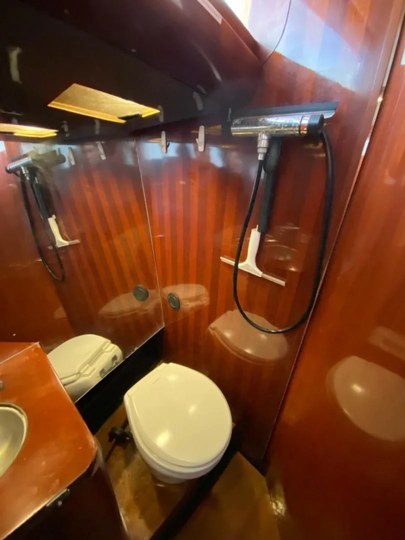 a bathroom with a toilet and a sink aboard LAUREN L Yacht for Sale