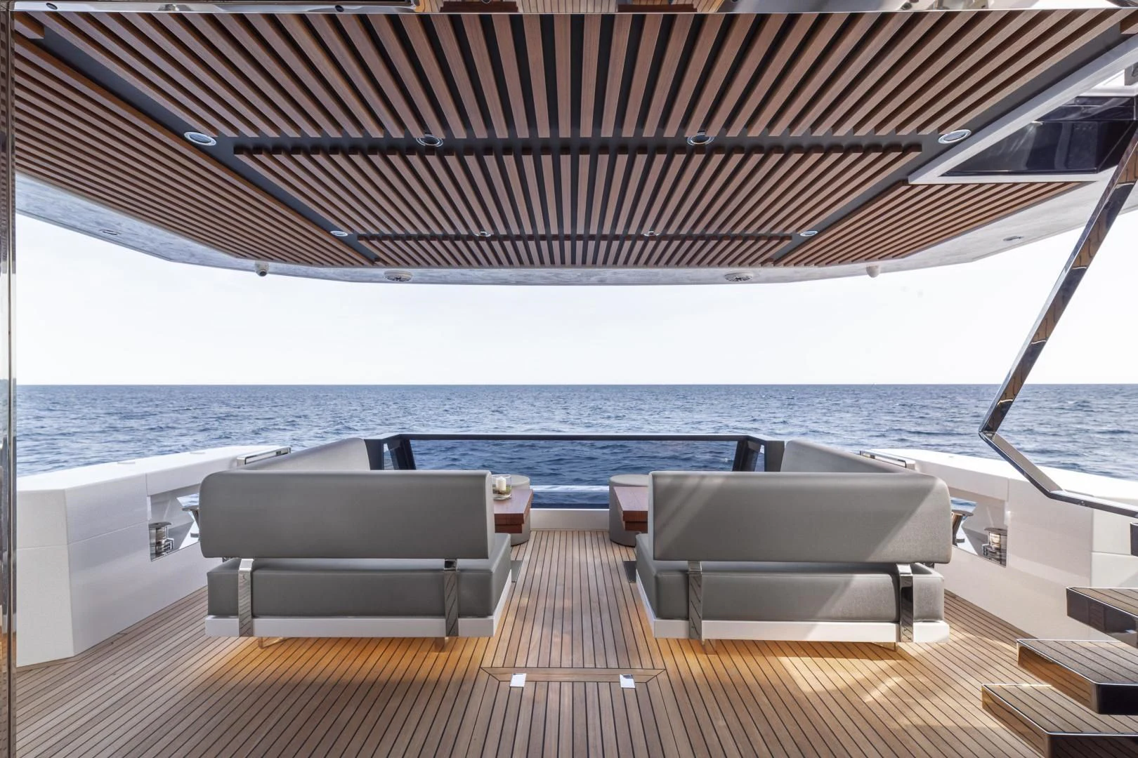a deck with chairs and a large body of water aboard SO SO NICE Yacht for Sale