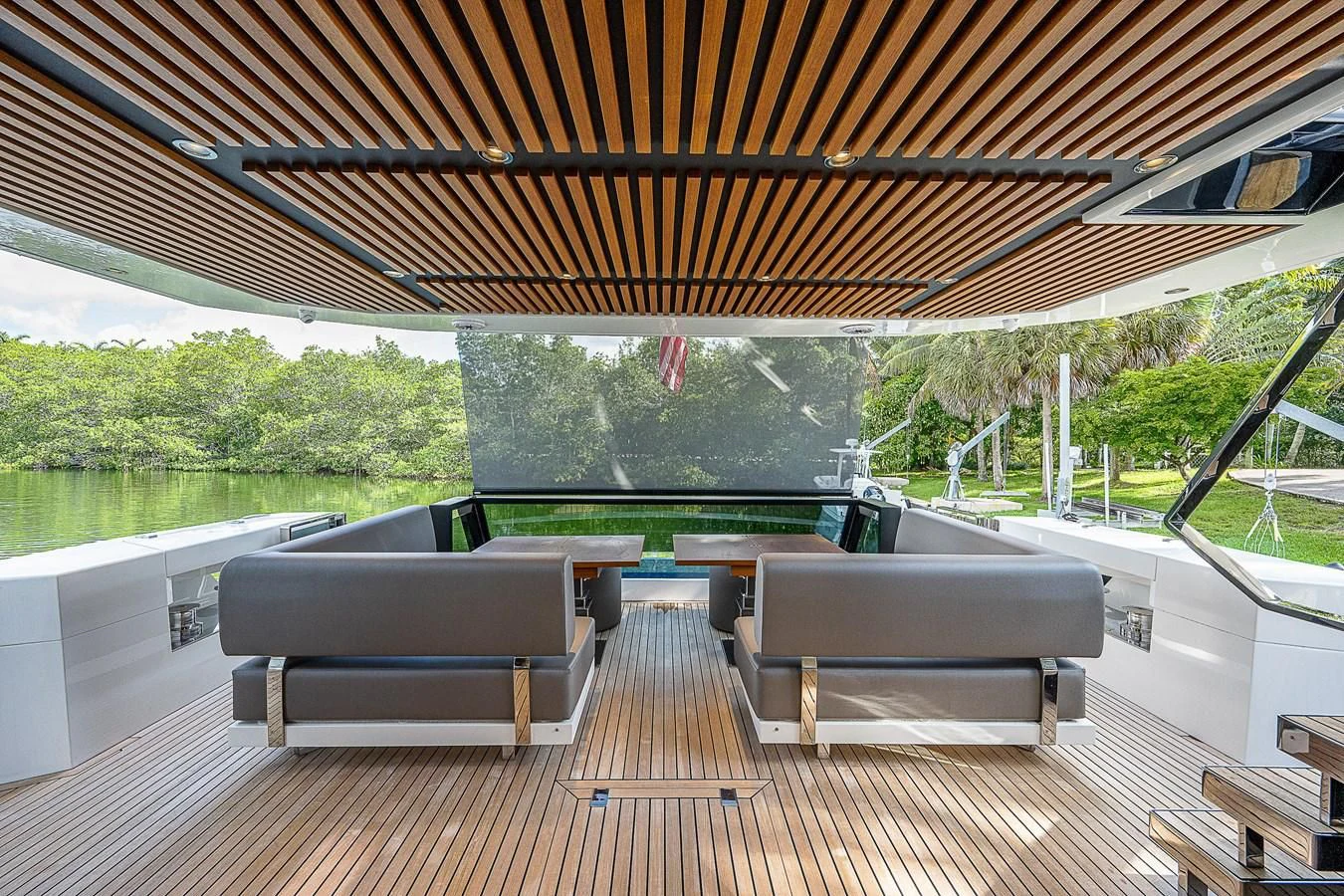 a covered patio with a picnic table and benches aboard SO SO NICE Yacht for Sale