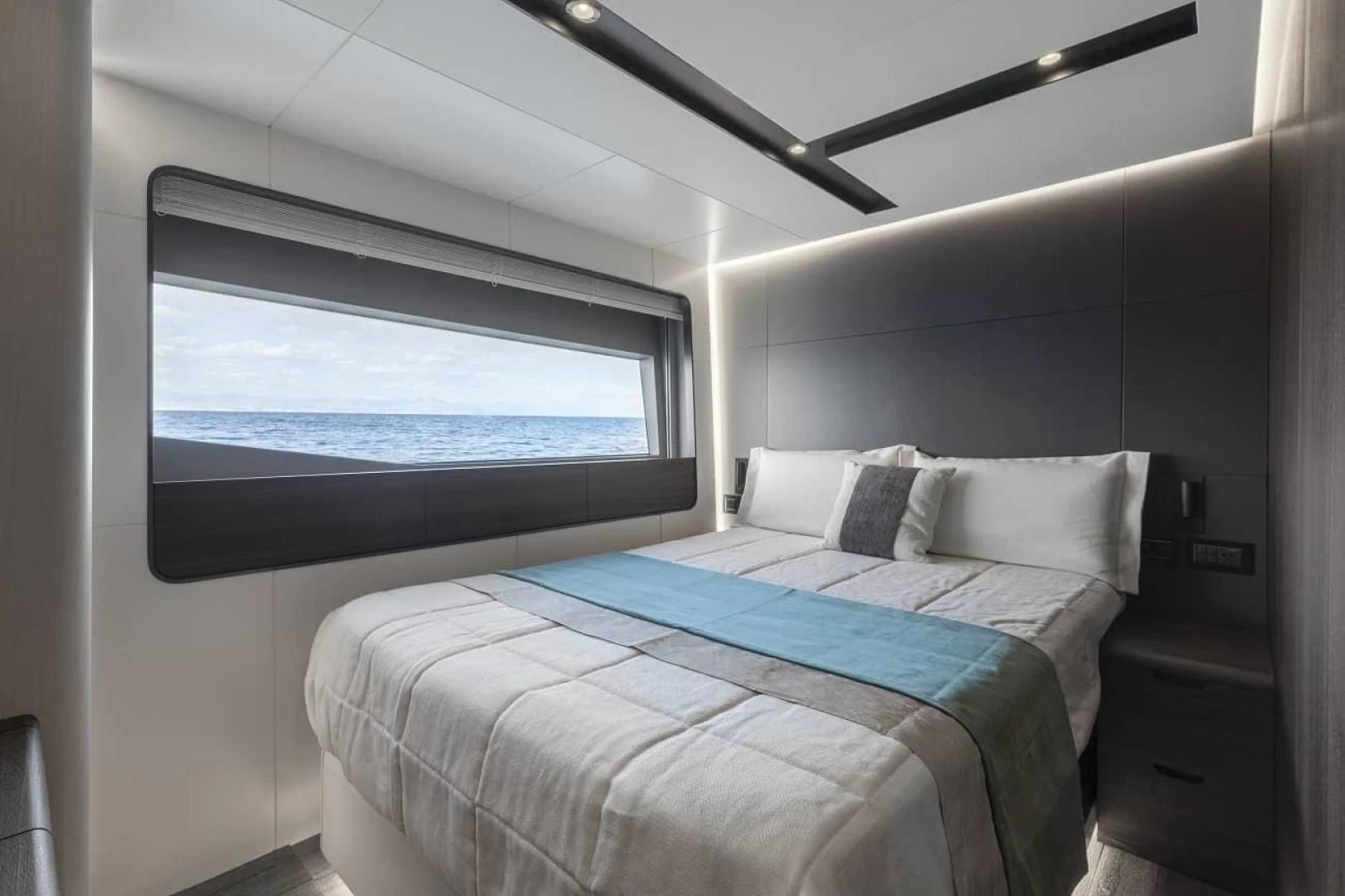 a room with a bed and a window aboard SO SO NICE Yacht for Sale