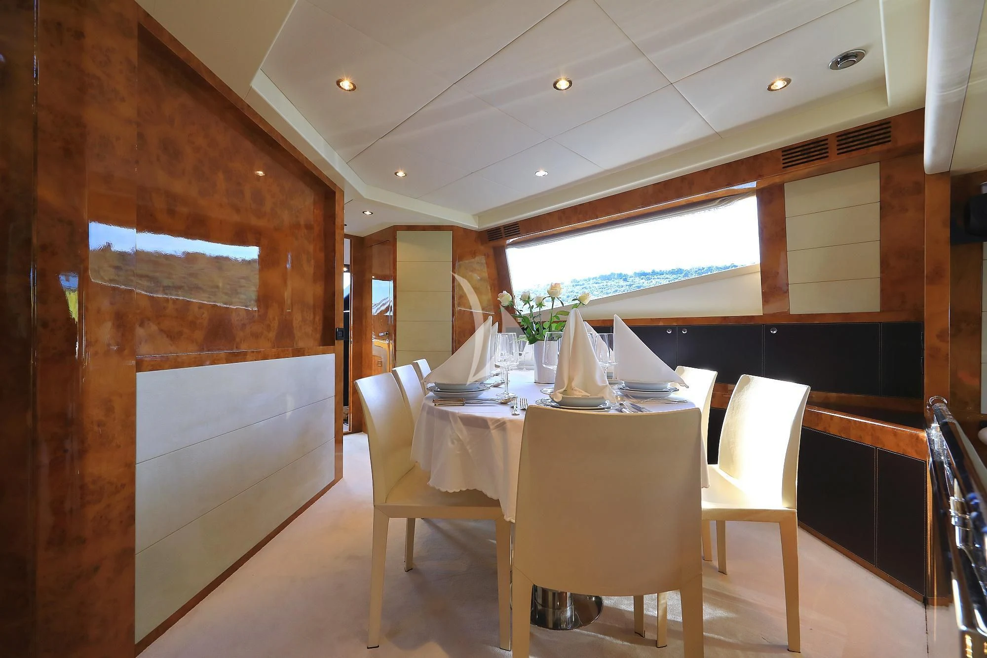 a room with tables and chairs aboard 888 Yacht for Sale