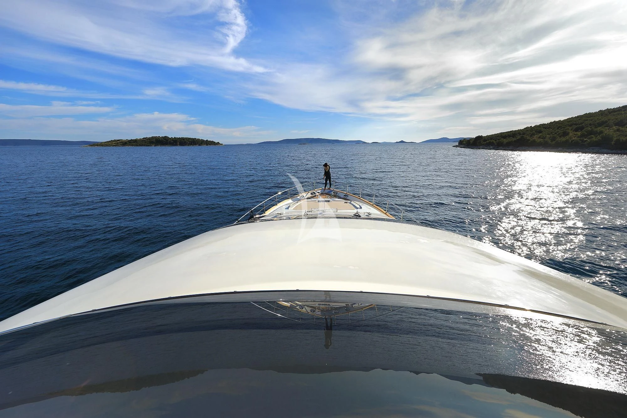 a person standing on a boat in the water aboard 888 Yacht for Sale