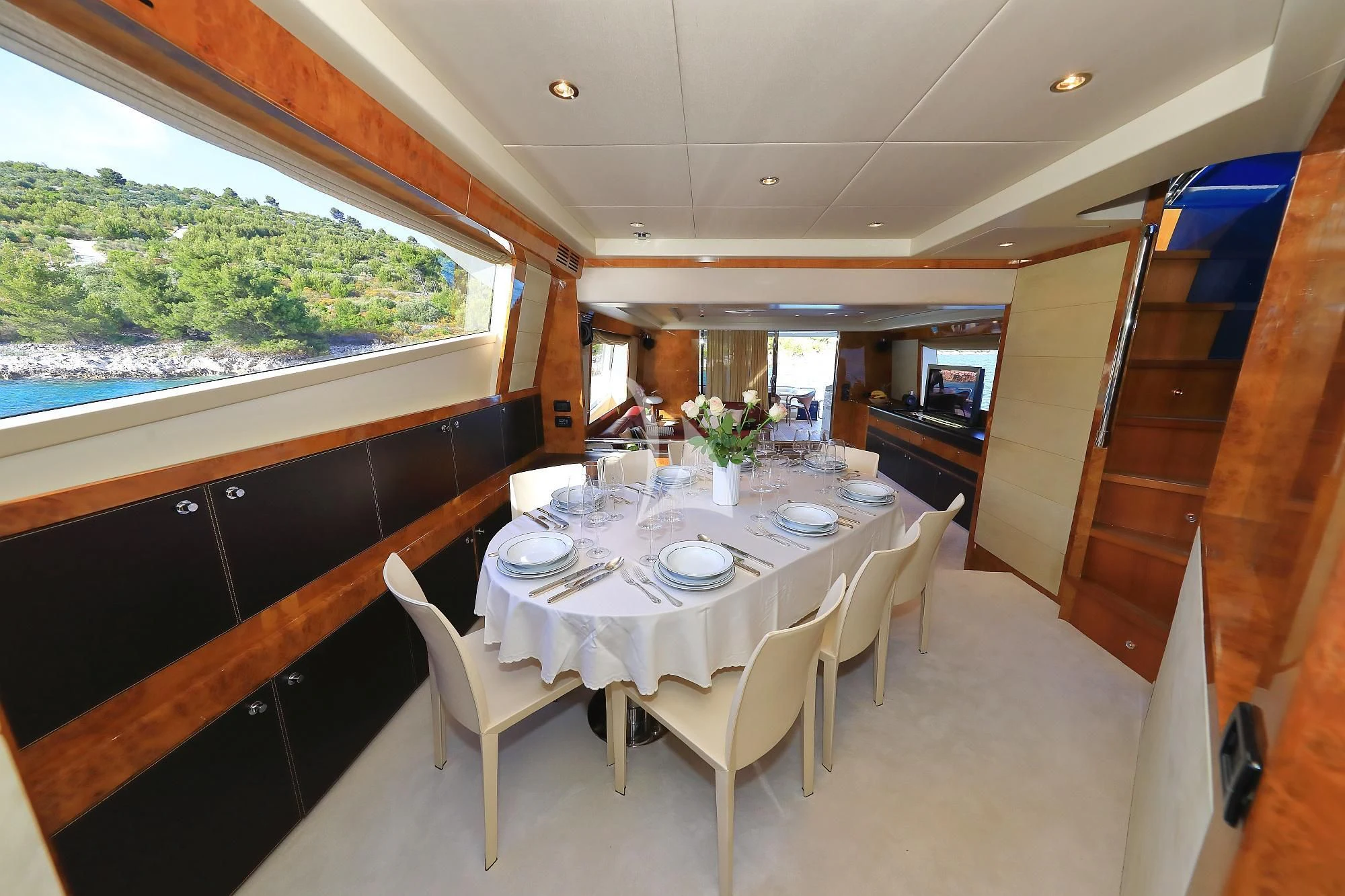 a dining table set for a meal aboard 888 Yacht for Sale