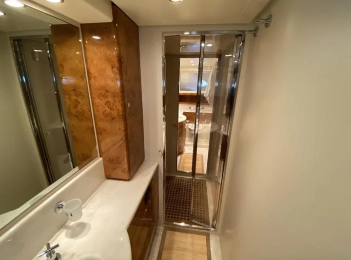 a bathroom with a glass shower aboard 888 Yacht for Sale