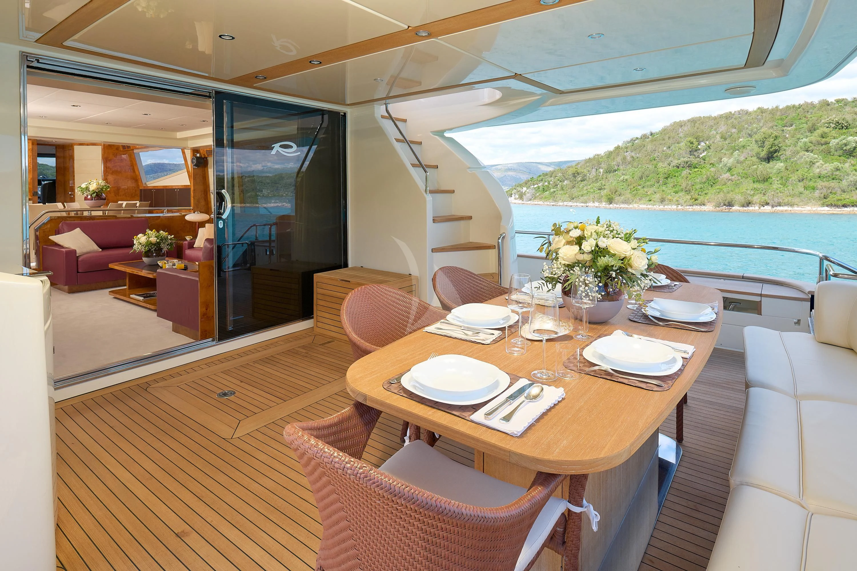 a dining table on a deck aboard 888 Yacht for Sale