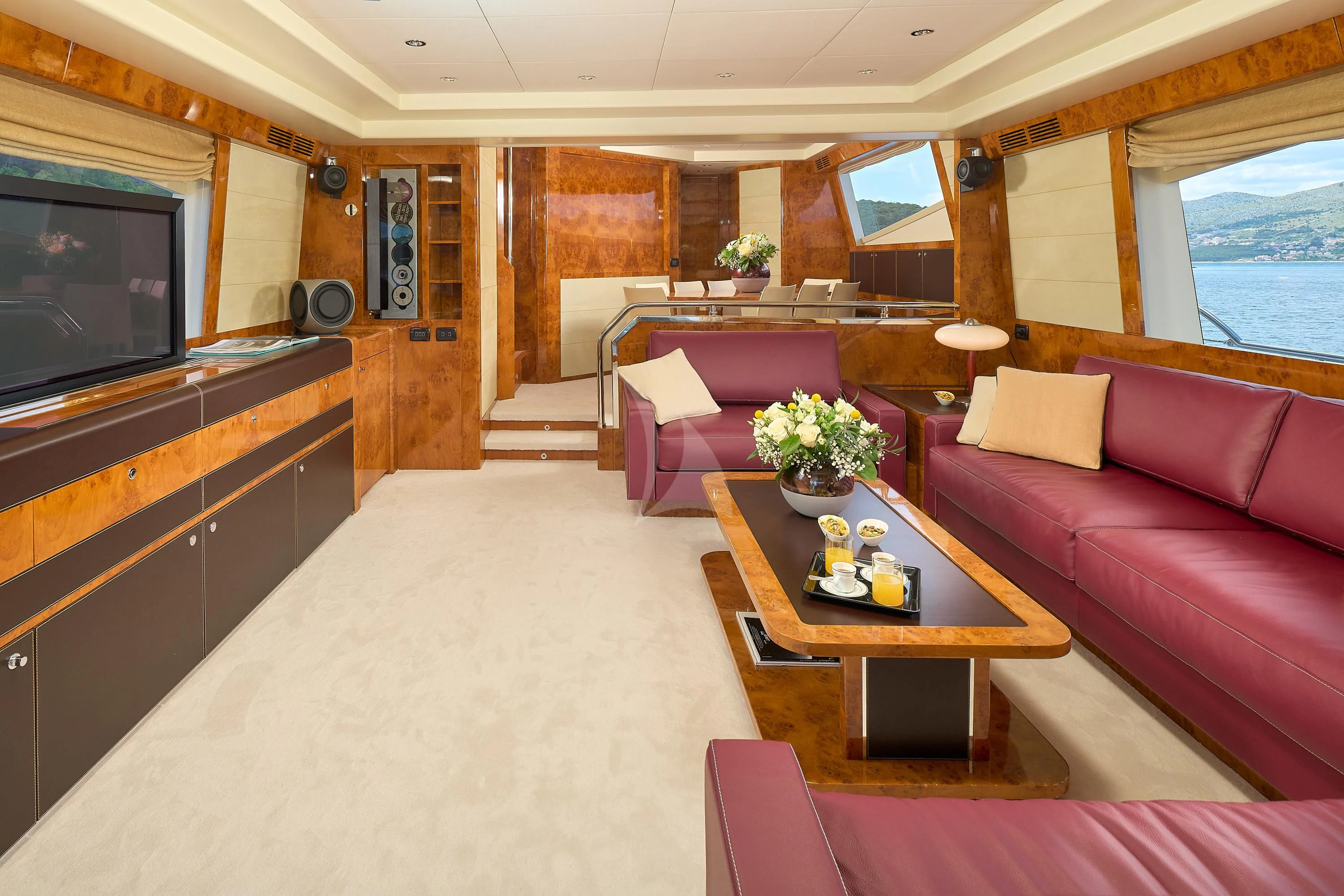 a living room with a couch and a television aboard 888 Yacht for Sale