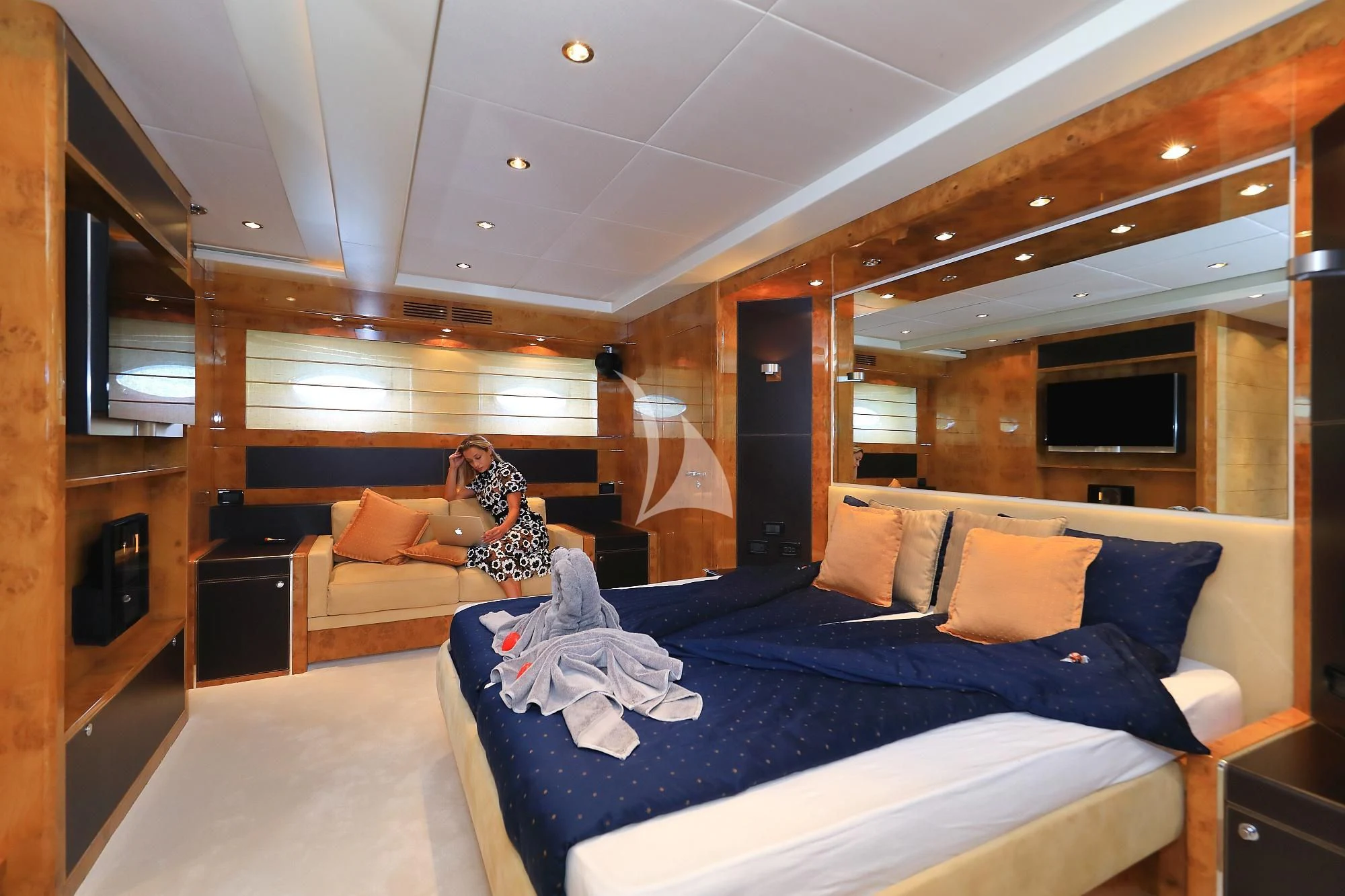 a couple of people sitting on a bed in a room aboard 888 Yacht for Sale