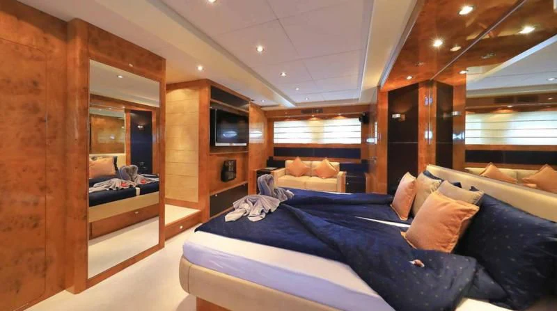 a room with a bed and a television aboard 888 Yacht for Sale