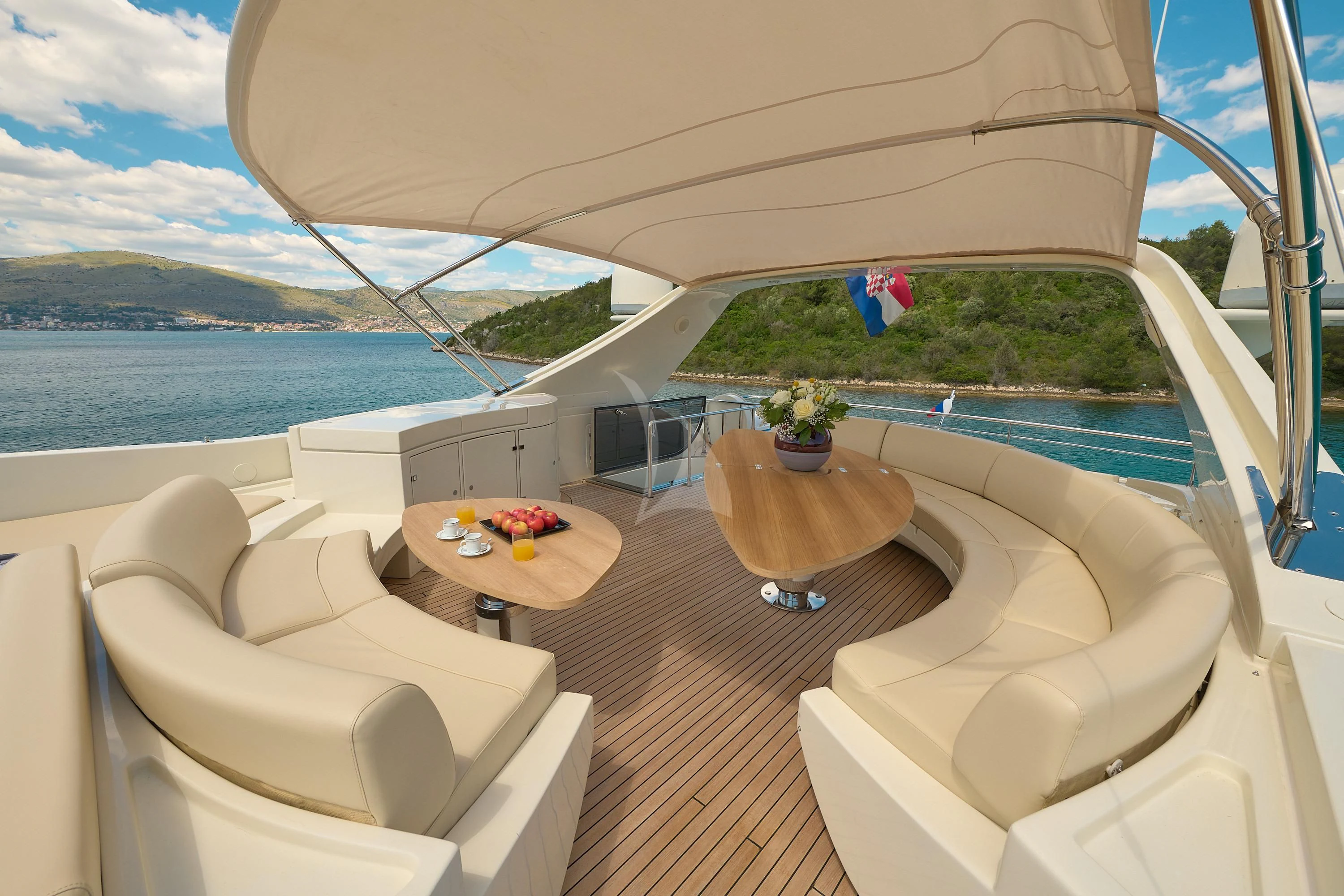 a balcony with a table and chairs aboard 888 Yacht for Sale