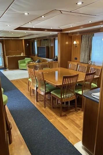 a large room with tables and chairs aboard SOL & SONS Yacht for Sale