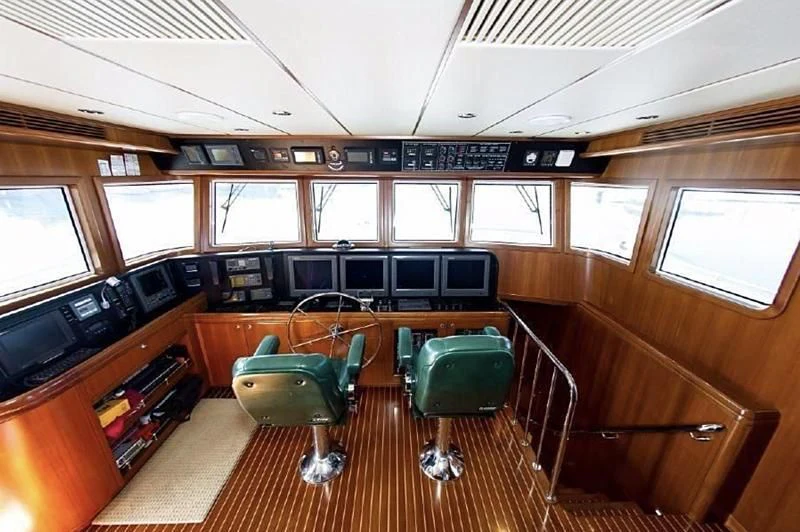 a room with a table chairs and a bench aboard SOL & SONS Yacht for Sale