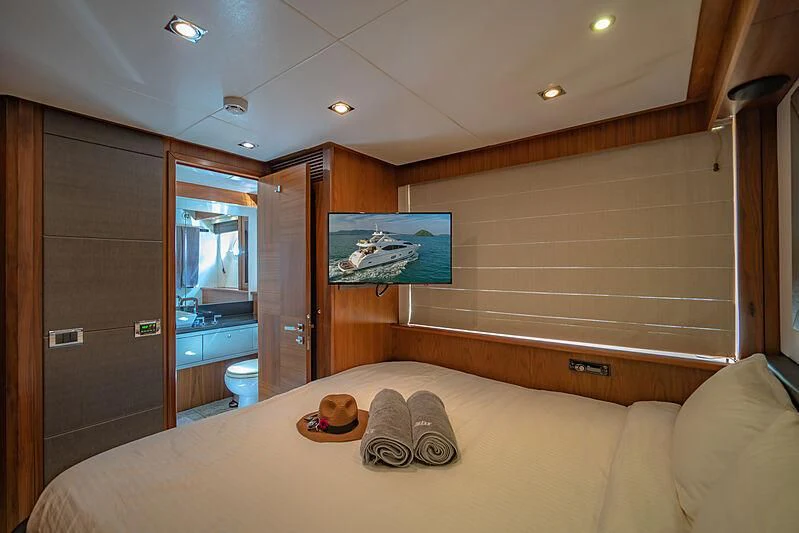 a bedroom with a bed and a mirror aboard SYDNEY Yacht for Charter