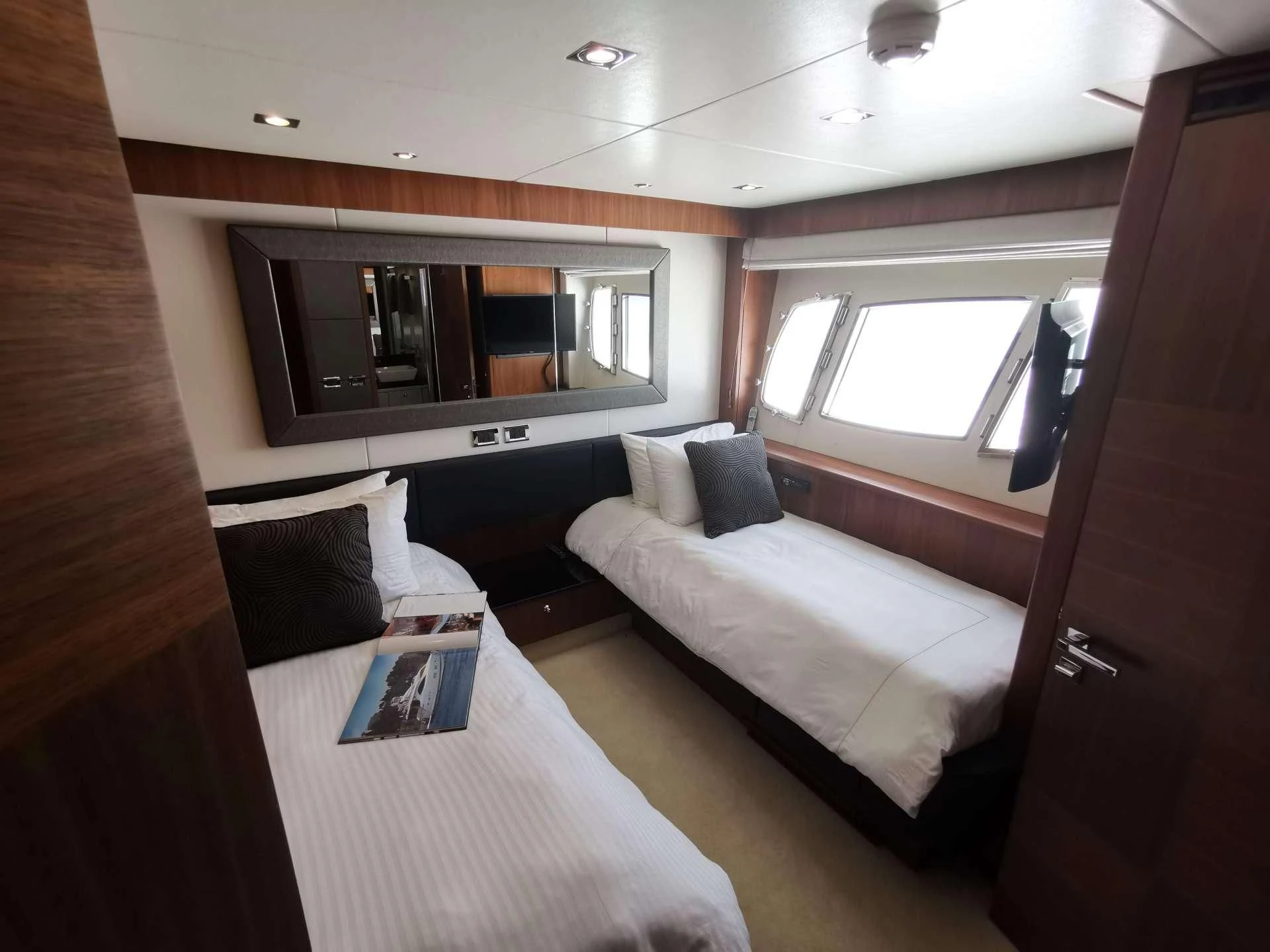 a room with a bed and a television aboard SYDNEY Yacht for Charter