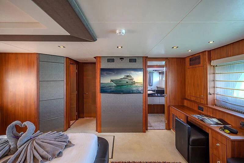 a room with a bed and a desk aboard SYDNEY Yacht for Charter