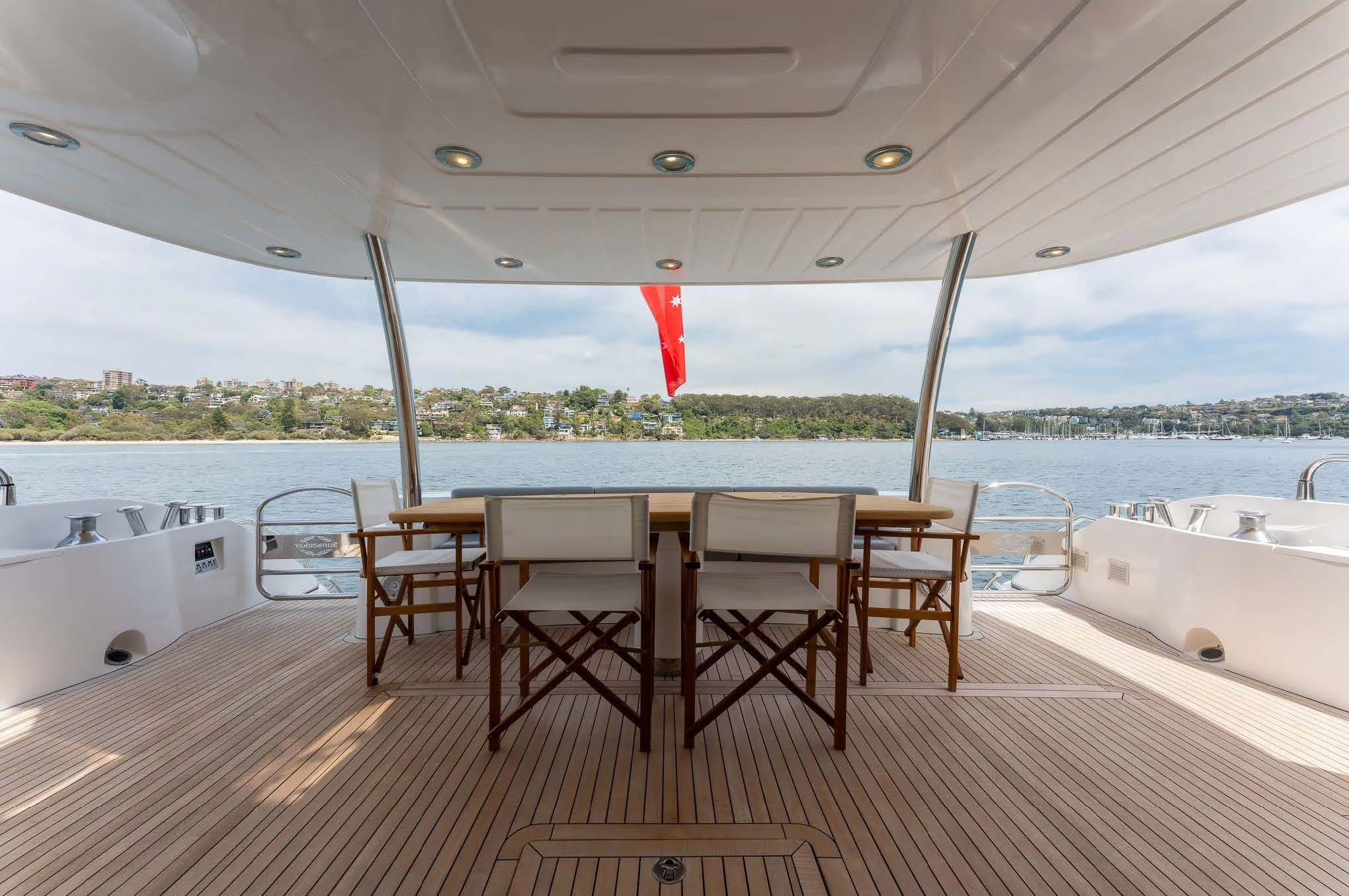 a table and chairs on a deck aboard SYDNEY Yacht for Charter