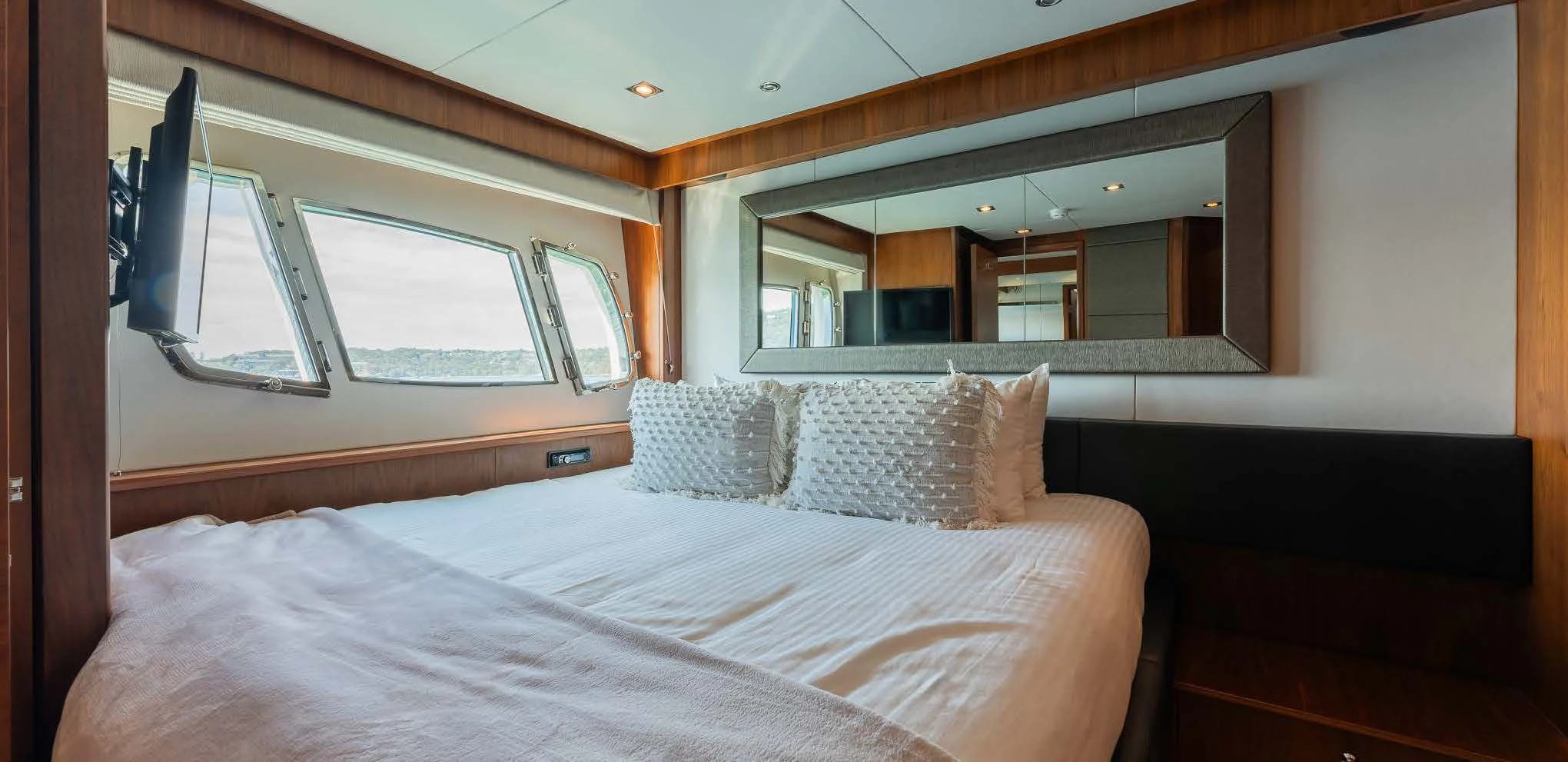 a bed with pillows aboard SYDNEY Yacht for Charter