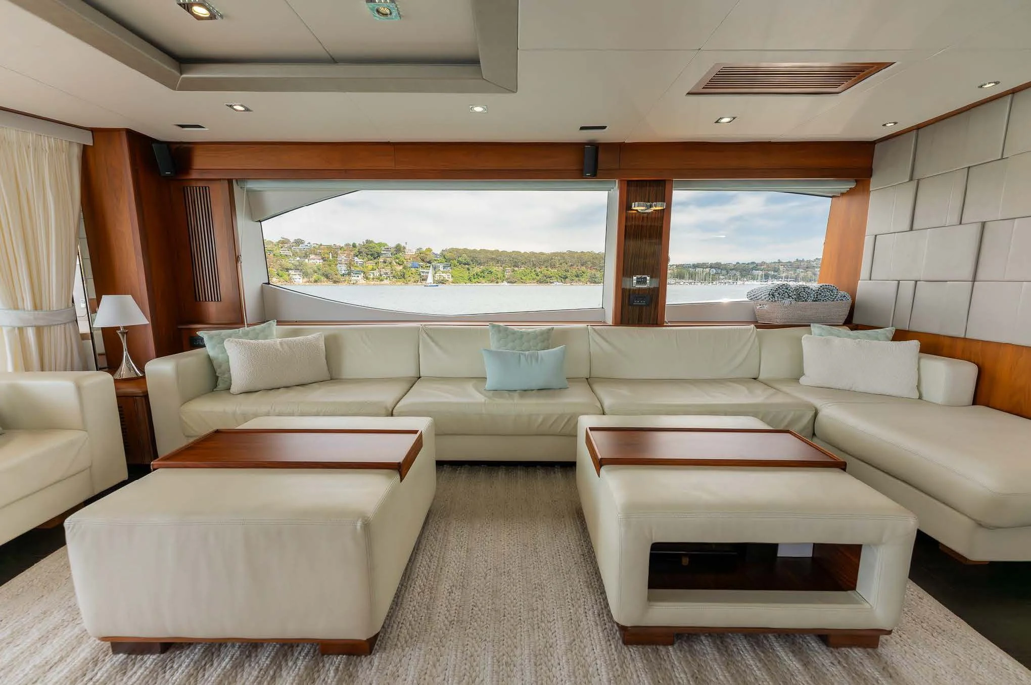 a living room with a large window aboard SYDNEY Yacht for Charter