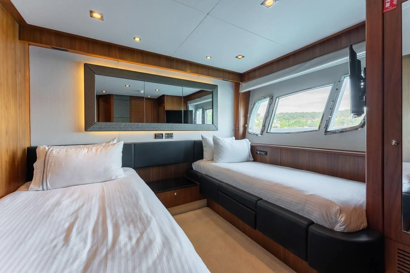 a couple of beds in a room aboard SYDNEY Yacht for Charter