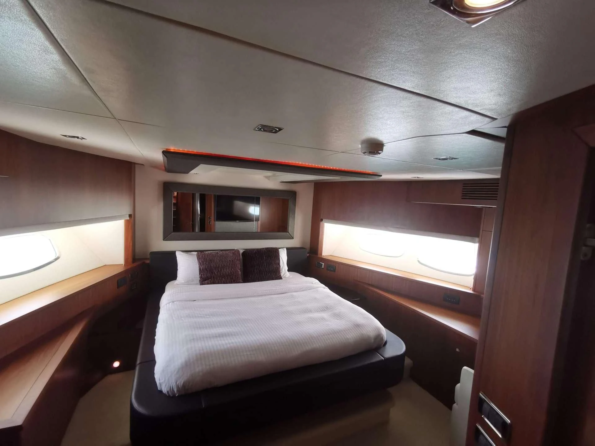 a room with a bed and a window aboard SYDNEY Yacht for Charter